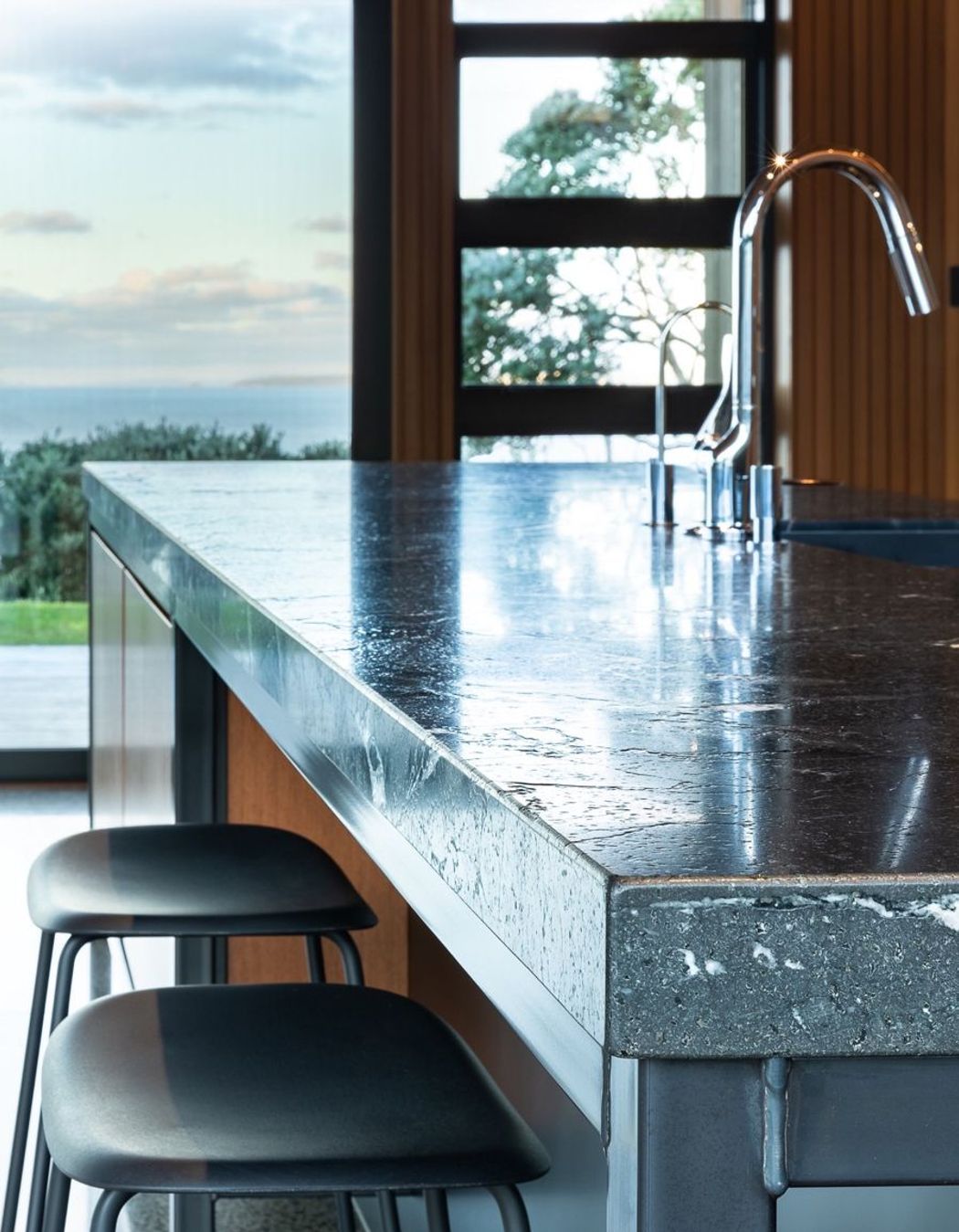 Continuing the industrial patina, a hand-crafted, blackened steel frame creates a bold foundation to the island’s structure. Exposed welds express the raw ‘honesty’ of its fabrication, however, the thick welds conflicted with square edges of teak panels.