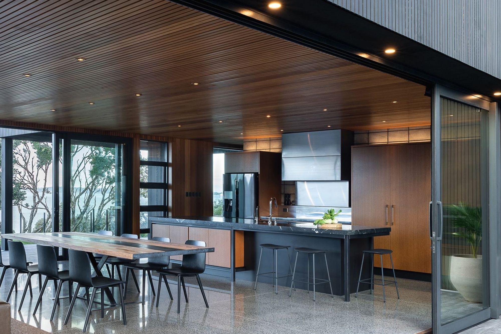 They needed organisation, a baking area, generous benches, flow to both outdoor areas and a welcoming space for family connection. Finding us late in their build programme, electrical holes already peppered the feature block wall.