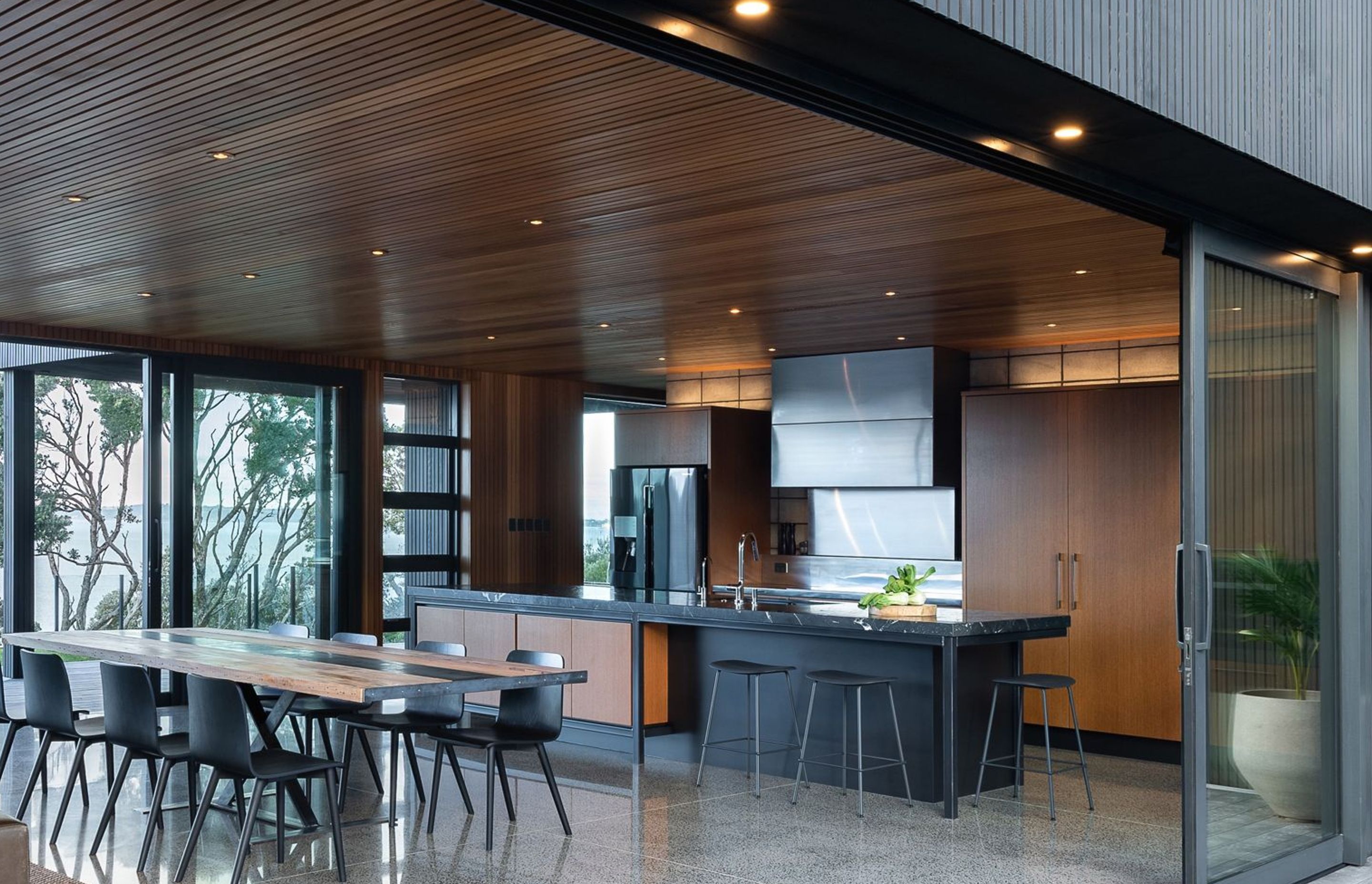 They needed organisation, a baking area, generous benches, flow to both outdoor areas and a welcoming space for family connection.  Finding us late in their build programme, electrical holes already peppered the feature block wall.