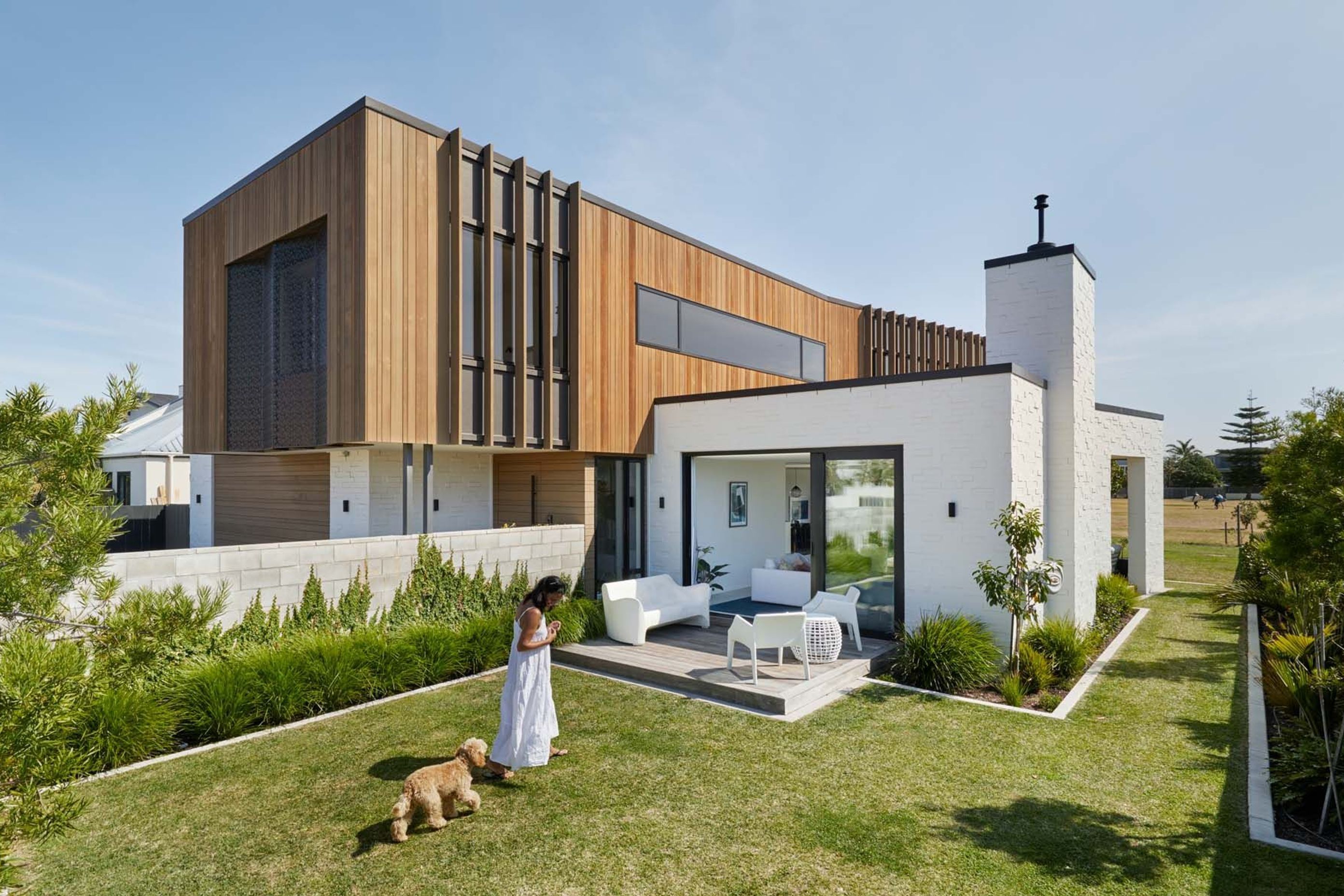 Cedar battens help to break up the side elevation and provide shade to the upstairs bedrooms. The lounge opens up to a deck and a front lawn that will eventually host a swimming pool.