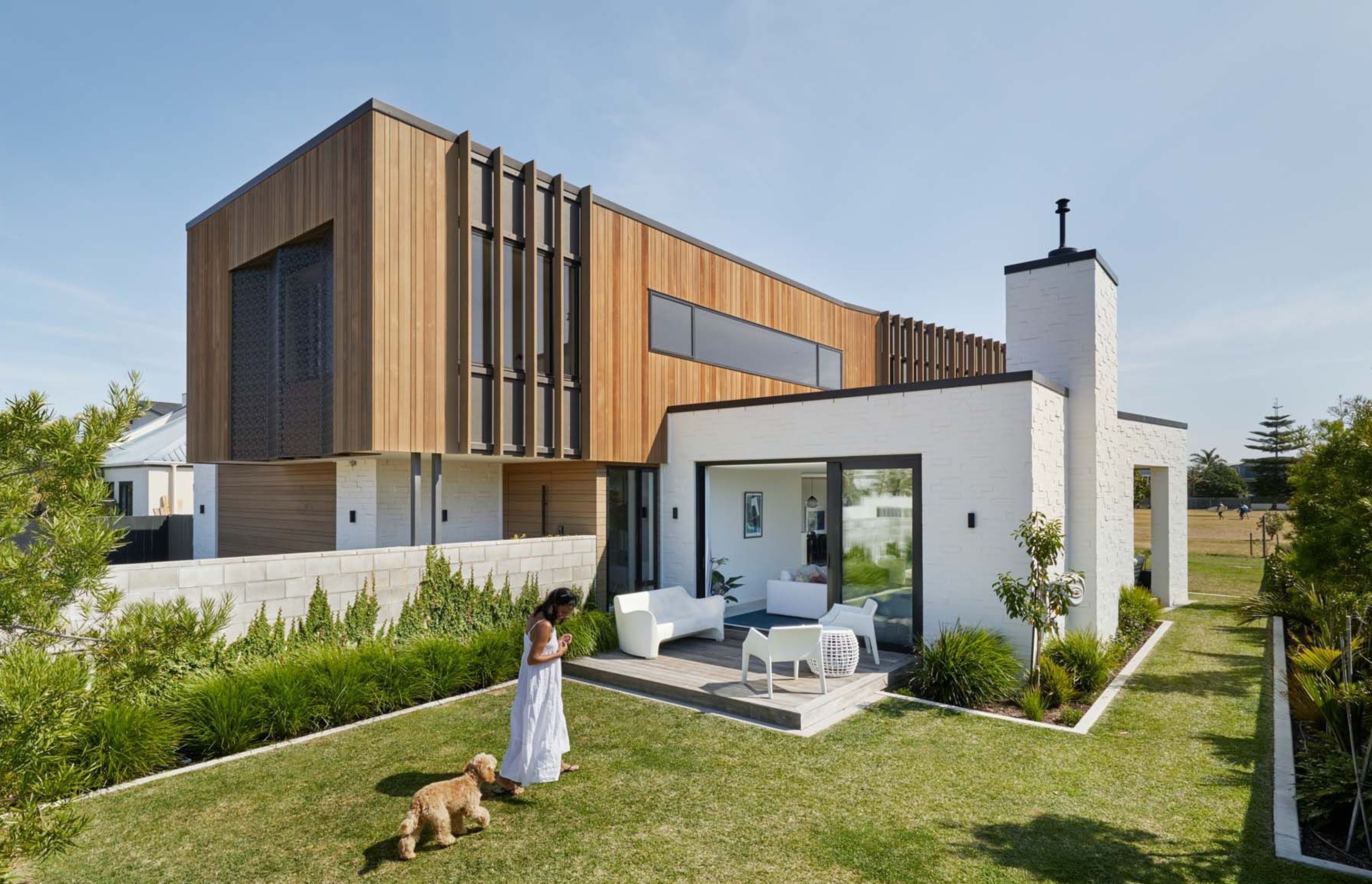 Cedar battens help to break up the side elevation and provide shade to the upstairs bedrooms. The lounge opens up to a deck and a front lawn that will eventually host a swimming pool.