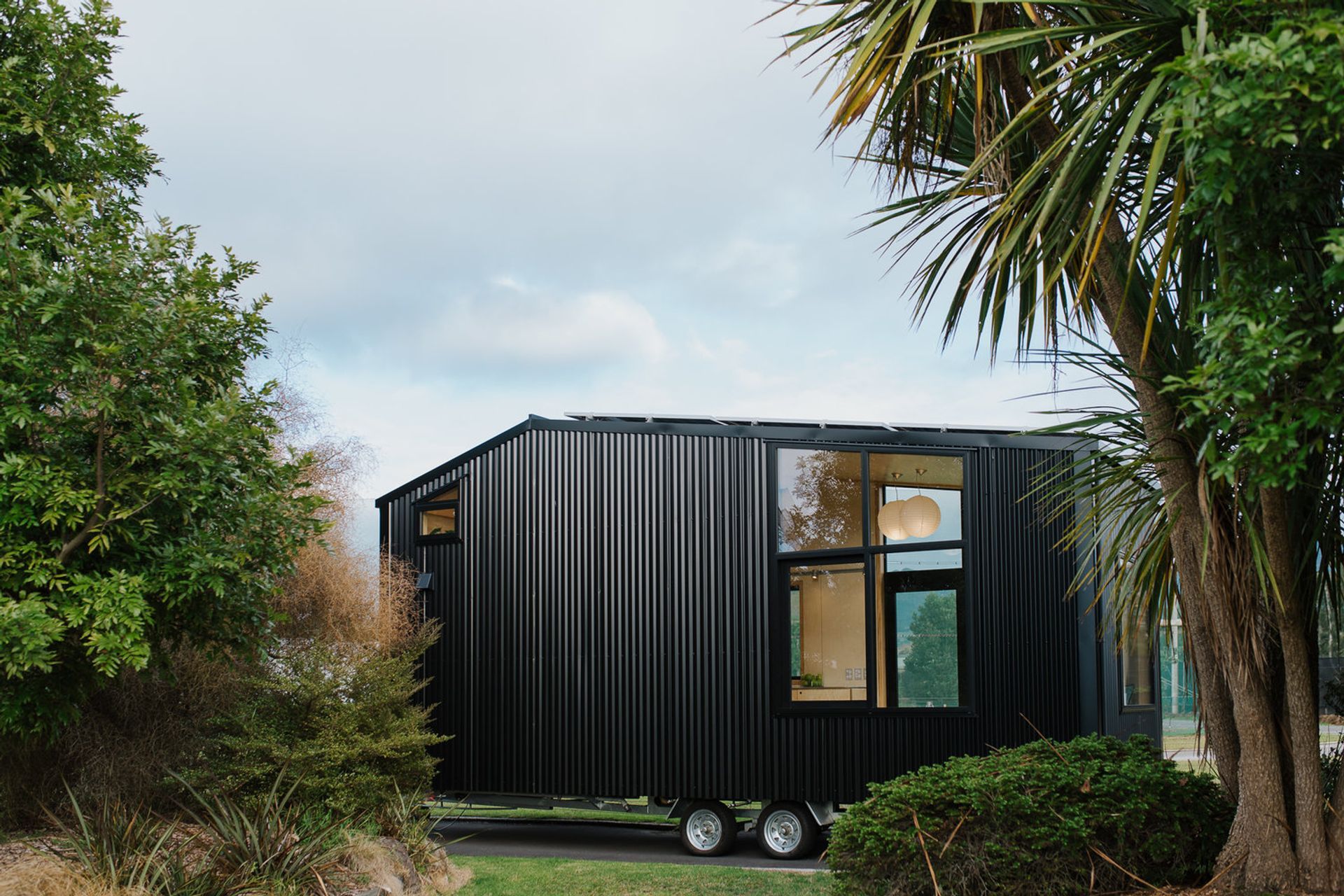 The other side of the Tiny Home features large windows so it can be positioned in either direction to maximise sunlight and views. Photography supplied by Build Tiny.