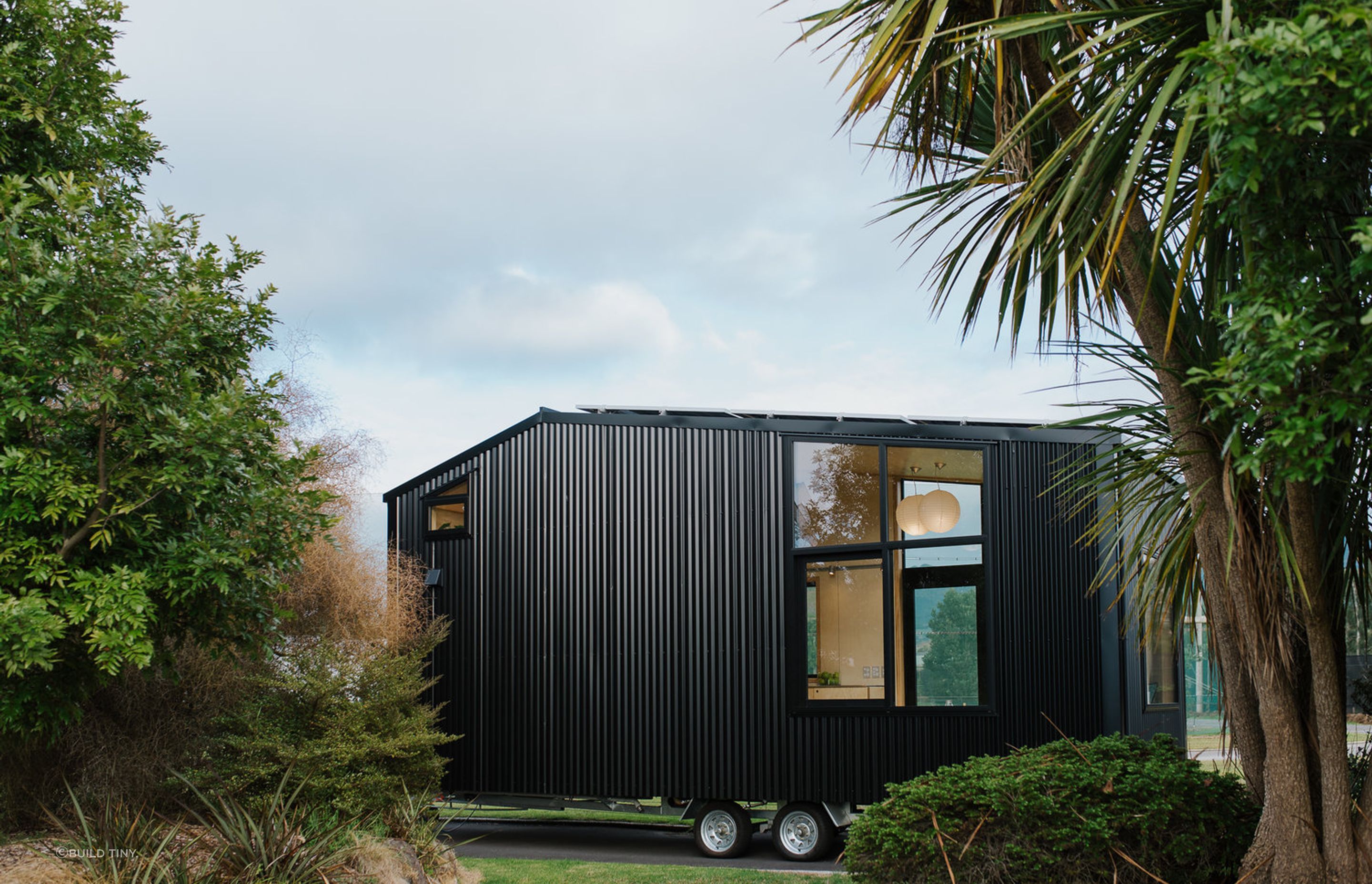 The other side of the Tiny Home features large windows so it can be positioned in either direction to maximise sunlight and views. Photography supplied by Build Tiny.