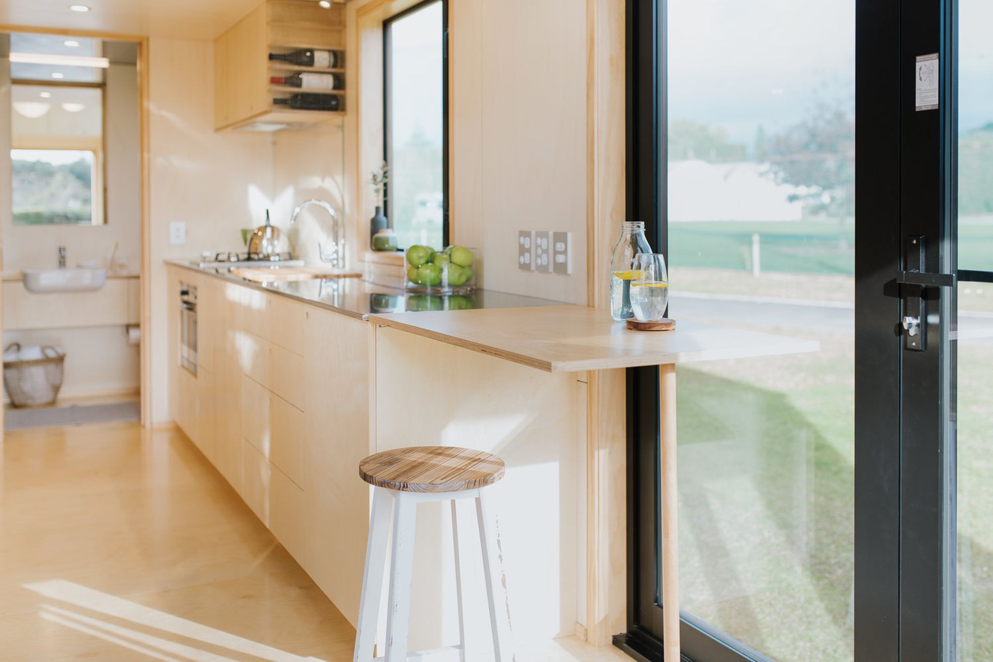 The kitchen bench extension doubles as a bar when the French doors are opened up – perfect for entertaining outside when the deck is completed.