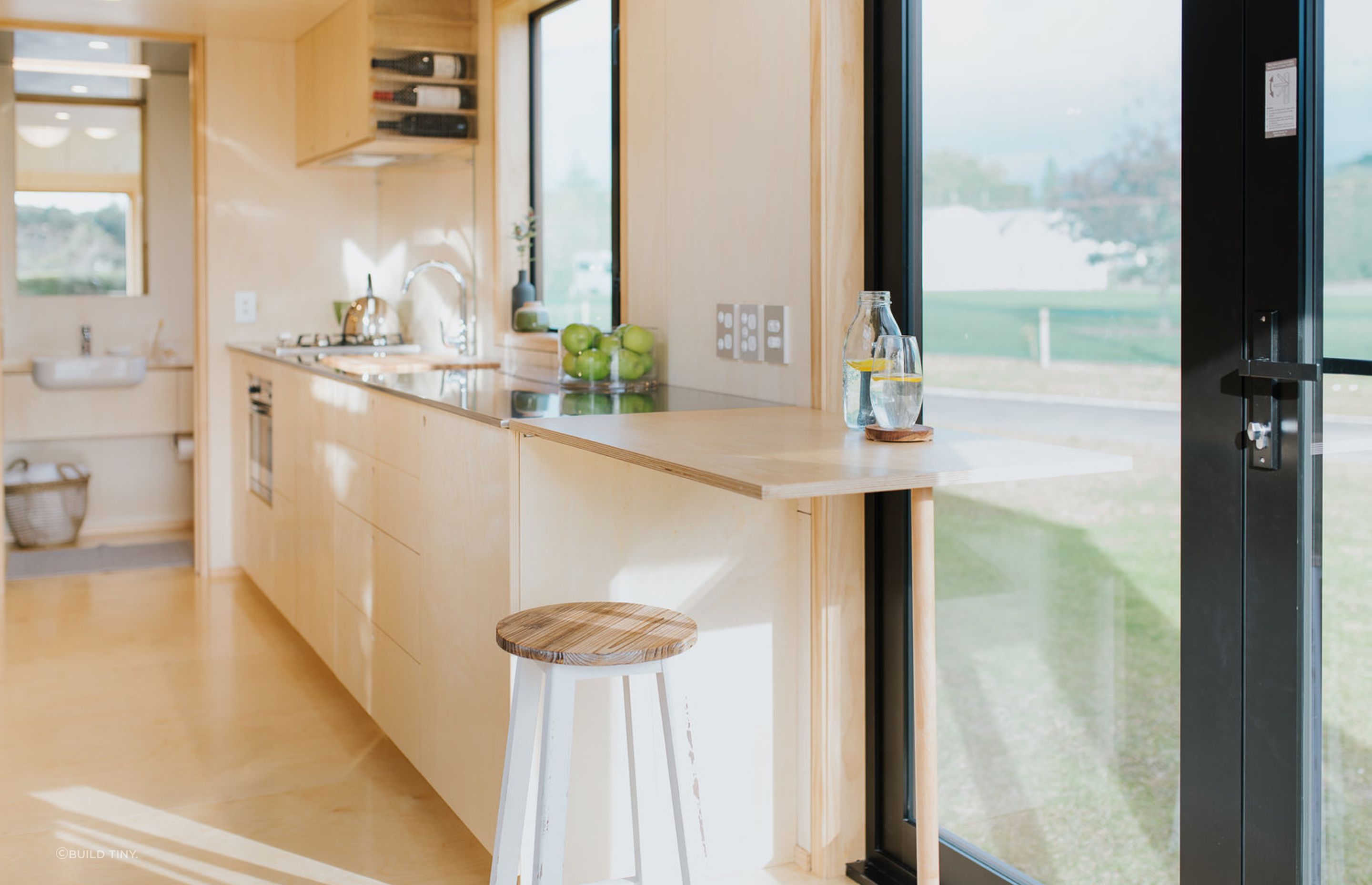 The kitchen bench extension doubles as a bar when the French doors are opened up – perfect for entertaining outside when the deck is completed.