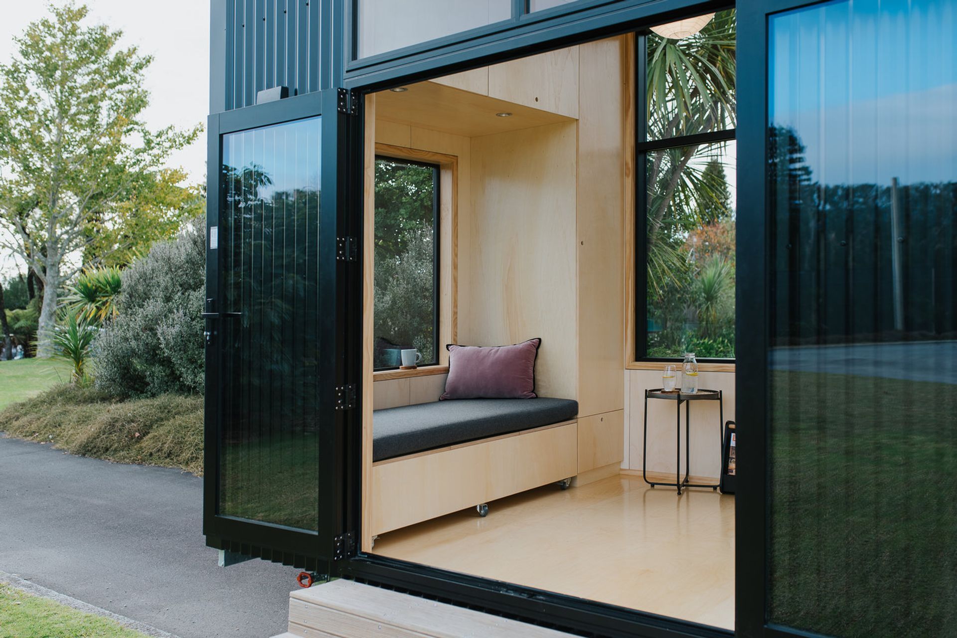 The windows and doors have been positioned for maximum light and flexibility, and every seat, stair and alcove doubles as storage. The window seat incorporates a pull-out day bed.