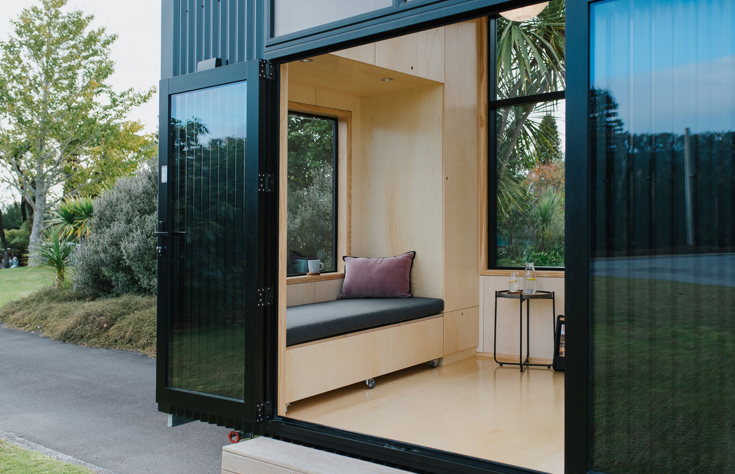 The windows and doors have been positioned for maximum light and flexibility, and every seat, stair and alcove doubles as storage. The window seat incorporates a pull-out day bed.