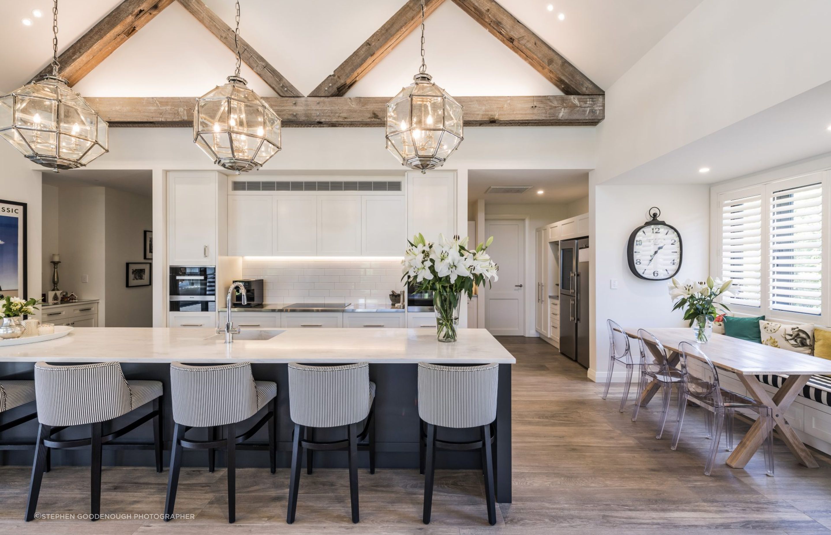 A classic white kitchen also acts as an informal dining area.