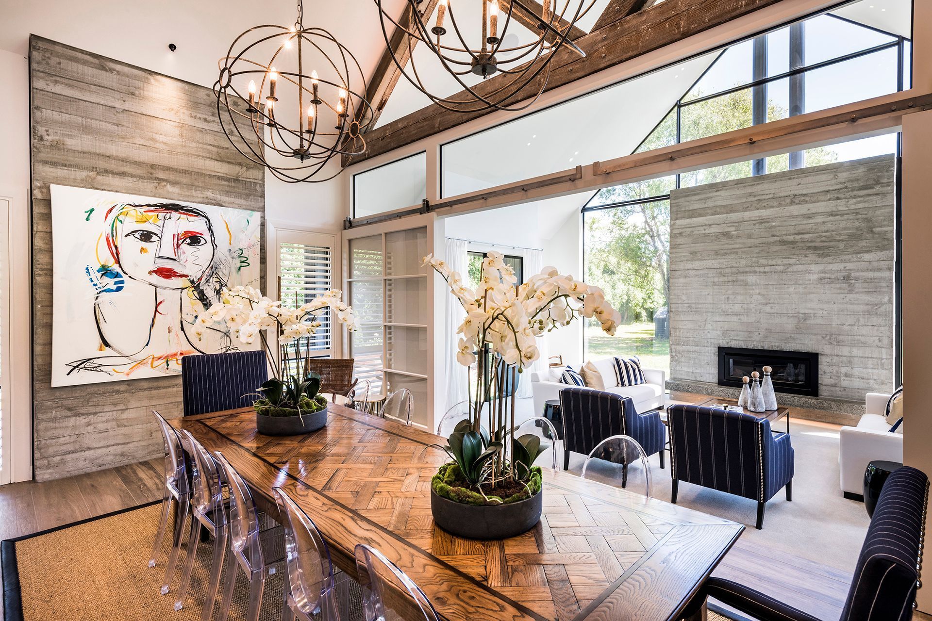 The dining area has an arty vibe, with paintings on the wall and a feature dining table with a parquet timber top.