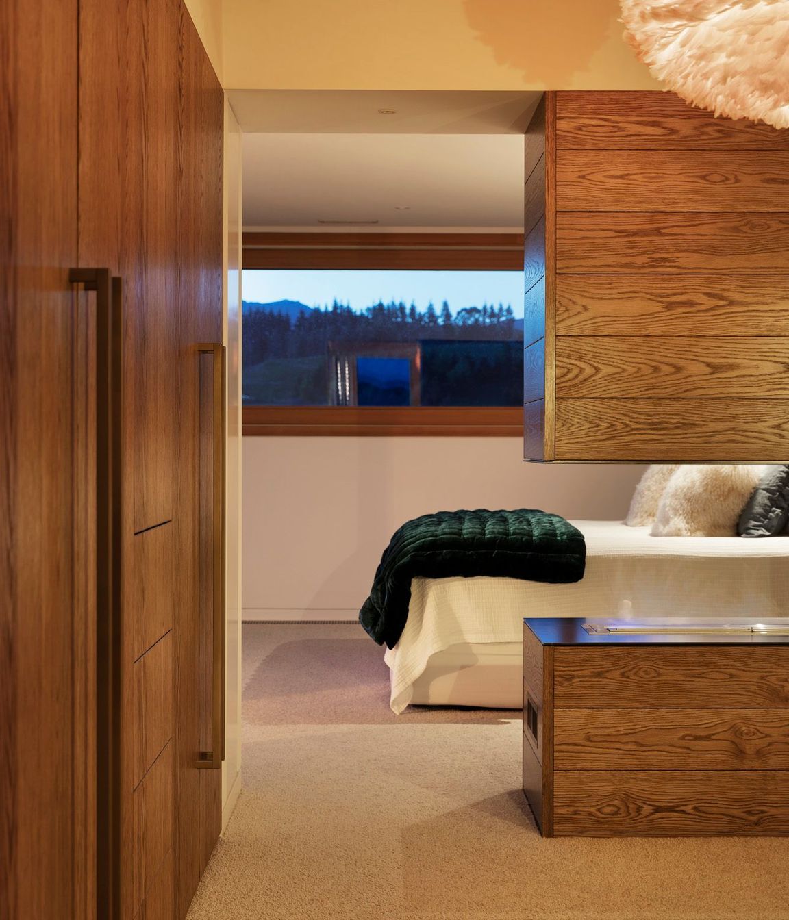 The master suite utilises bespoke oak cabinetry for plenty of storage.