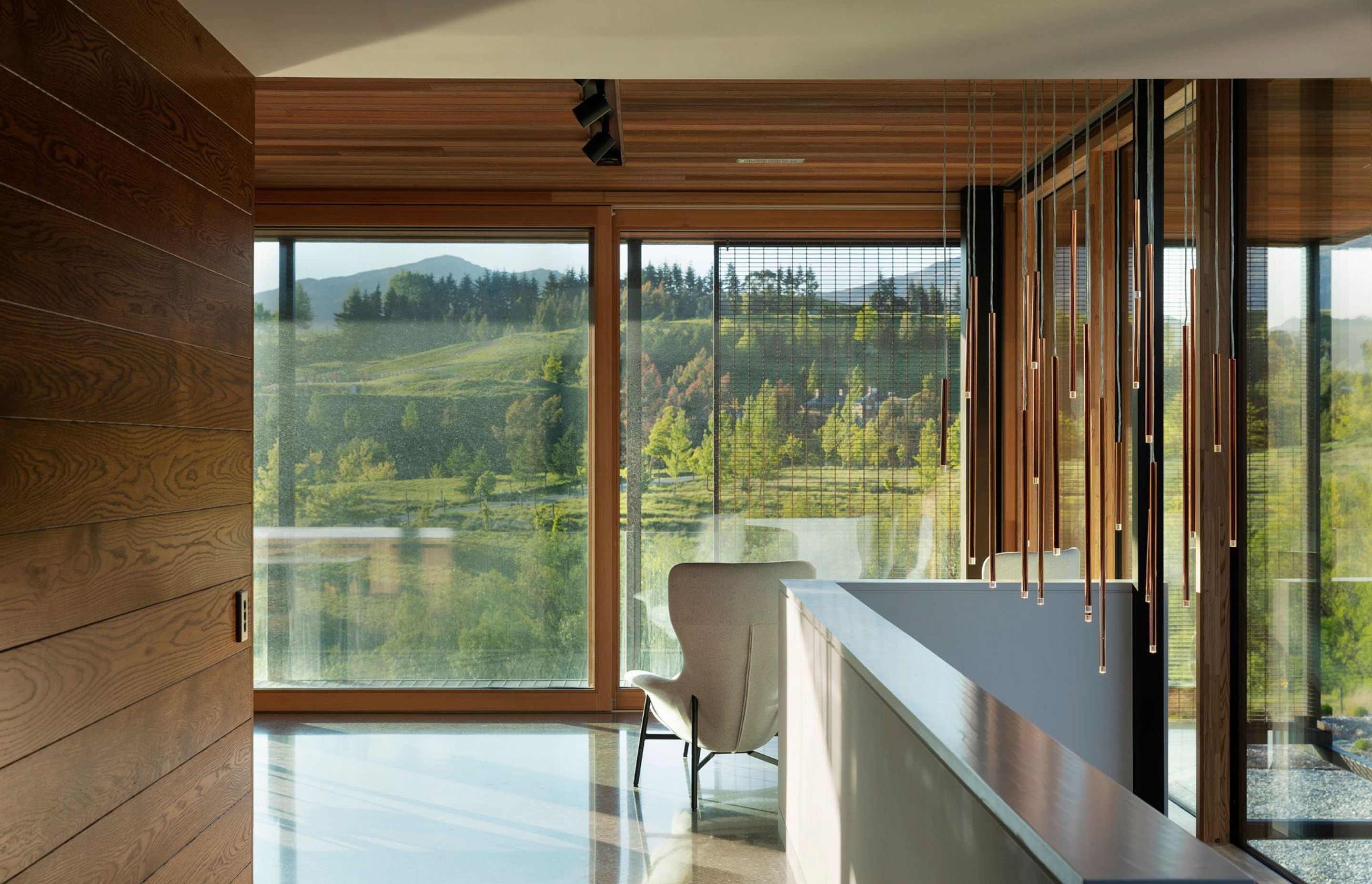 A hallway with a view and a feature light pendant.