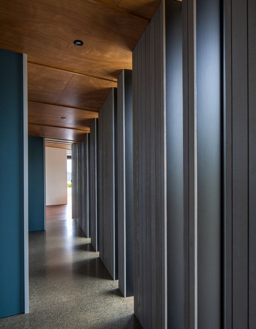 Full-length vertical windows along the hallway creates drama and adds light.