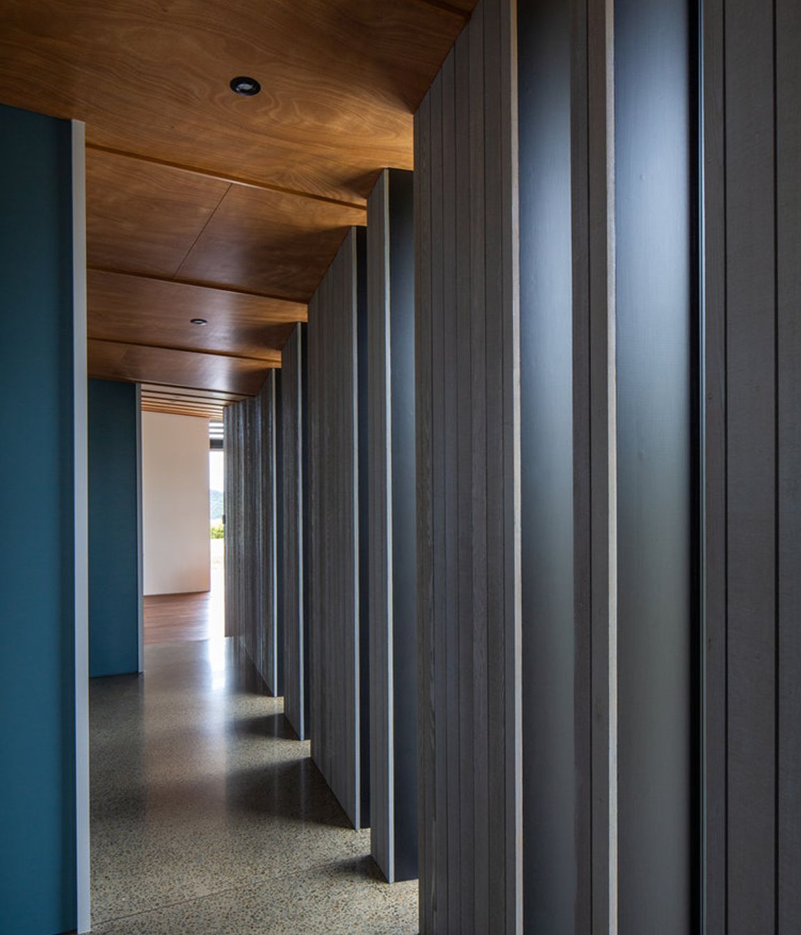 Full-length vertical windows along the hallway creates drama and adds light.