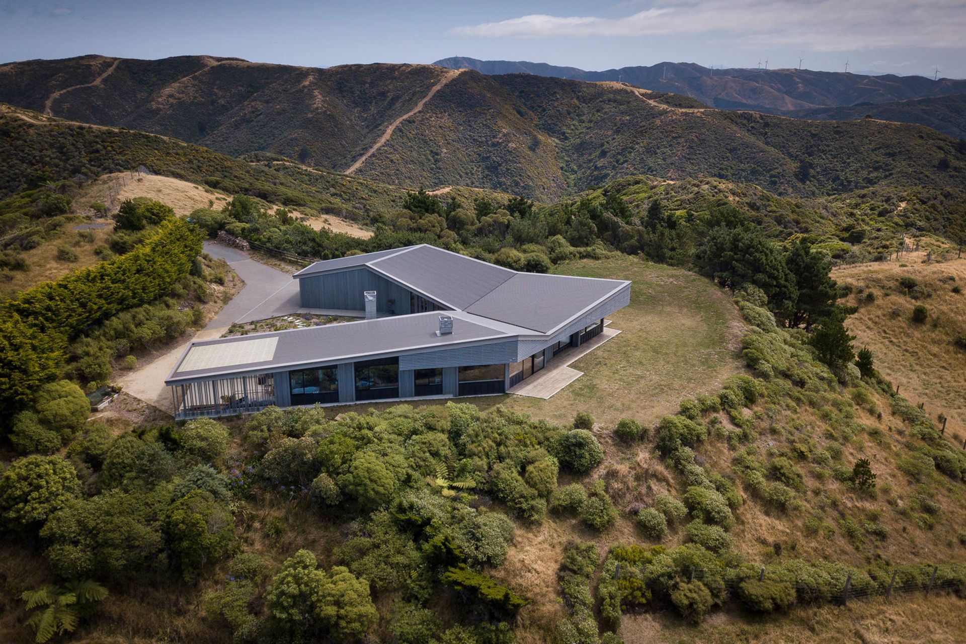 The U-shaped layout creates a sheltered courtyard at the rear. Rainwater is collected off the roof and stored in in-ground tanks for household use.