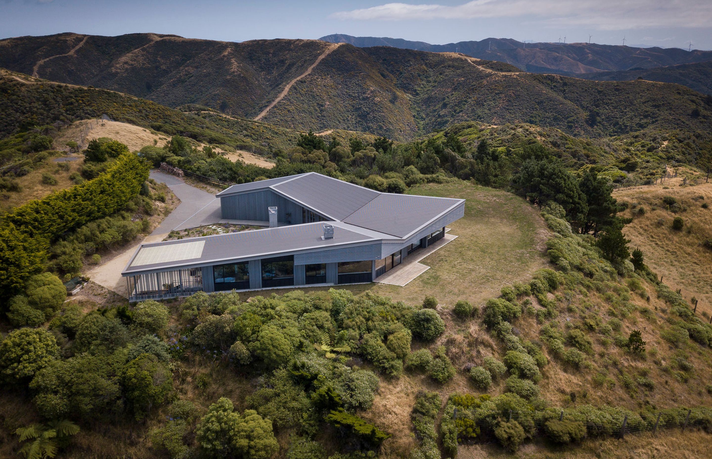 The U-shaped layout creates a sheltered courtyard at the rear. Rainwater is collected off the roof and stored in in-ground tanks for household use.