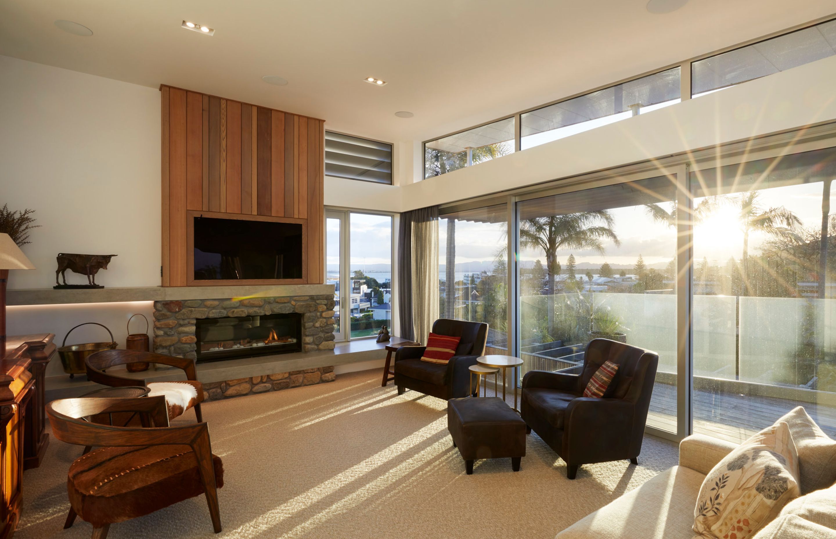 The living area features views towards Pilot Bay and a fireplace clad in stone sourced from the owners' previous property.