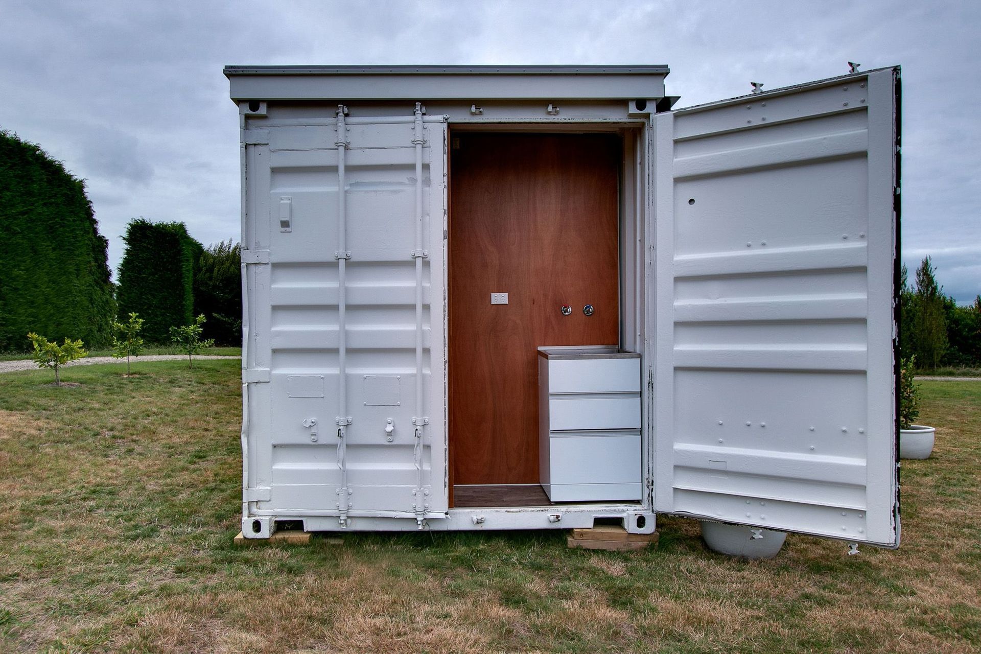 The doors of the existing container open up a laundry area to the exterior.