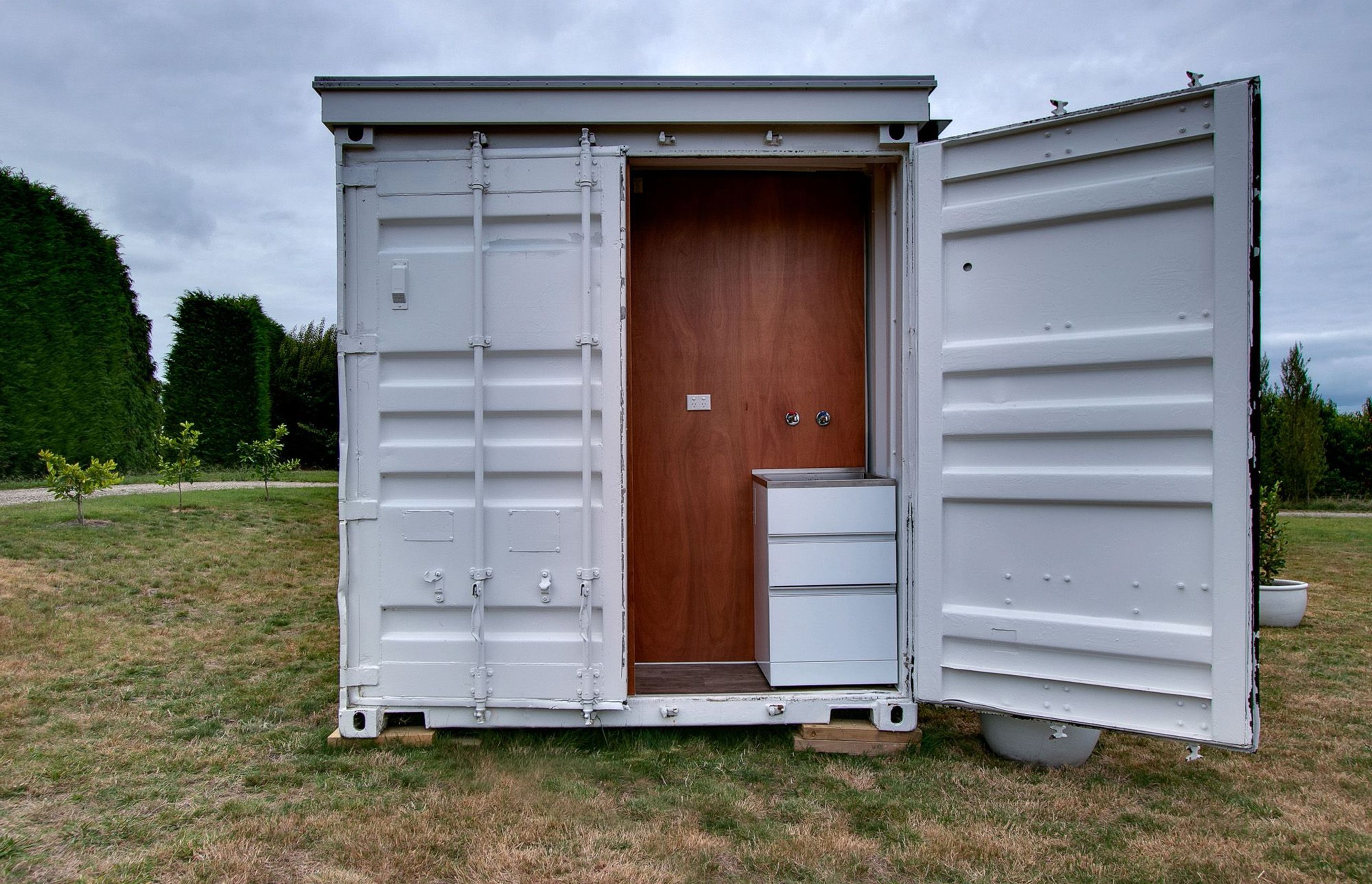 The doors of the existing container open up a laundry area to the exterior.
