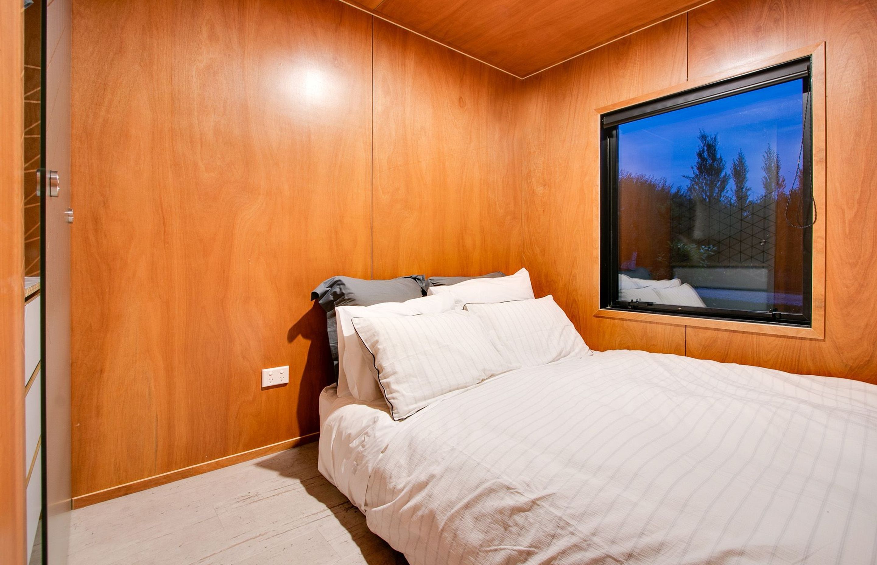 A simple bedroom has built in storage.