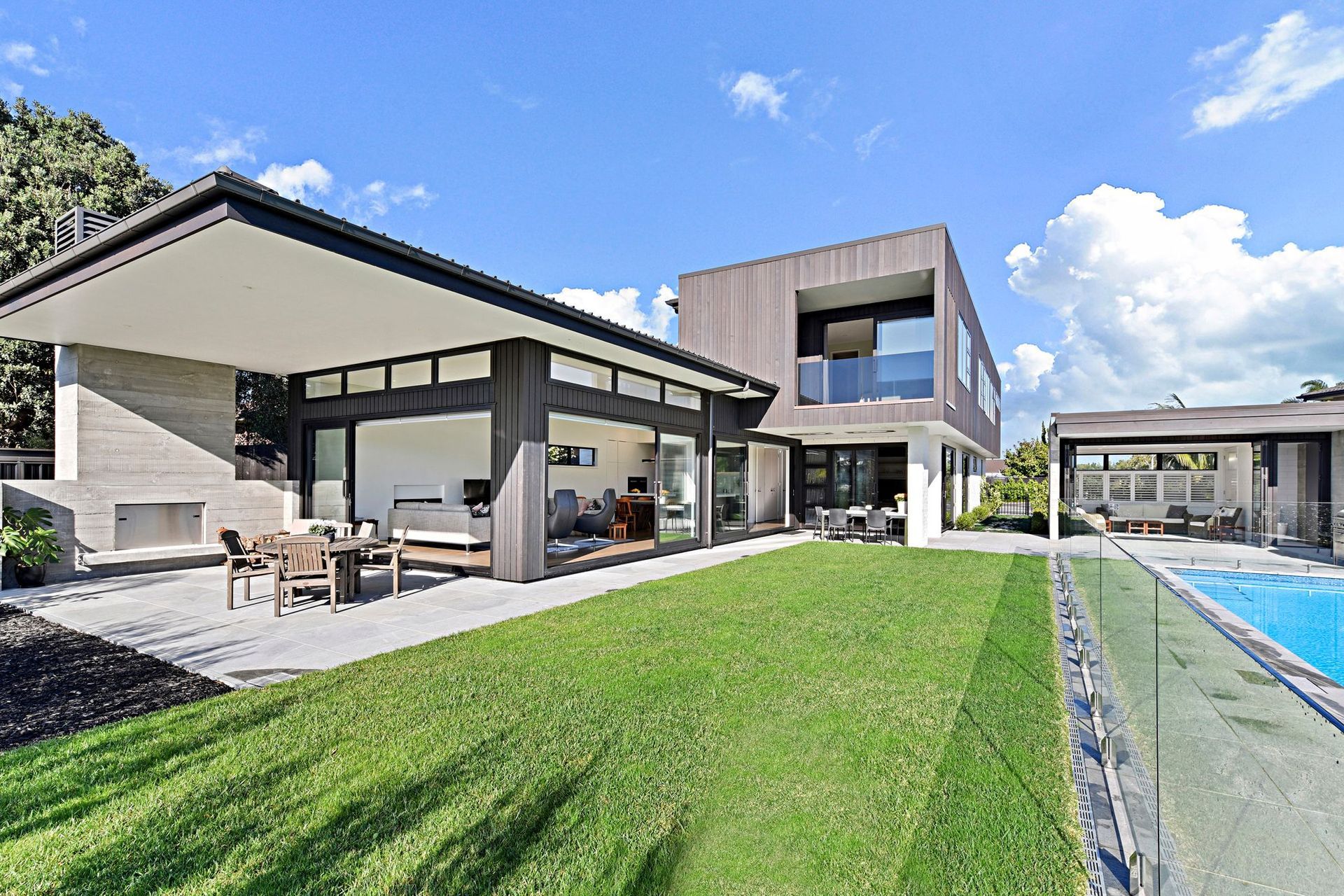 Effortlessly flowing from the lounge to the outdoor living area, nestled by the stunning concrete fireplace, you’re embraced by the opulence and warmth, promising a comfortable stay.