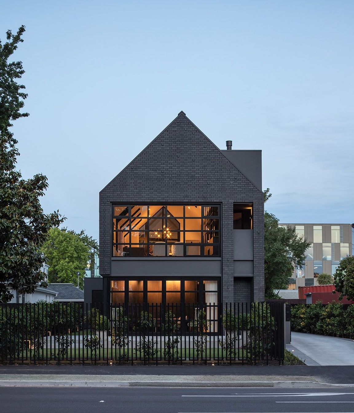 In the front garden, a simple paved patio looks directly across to the willows of Hagley Park.