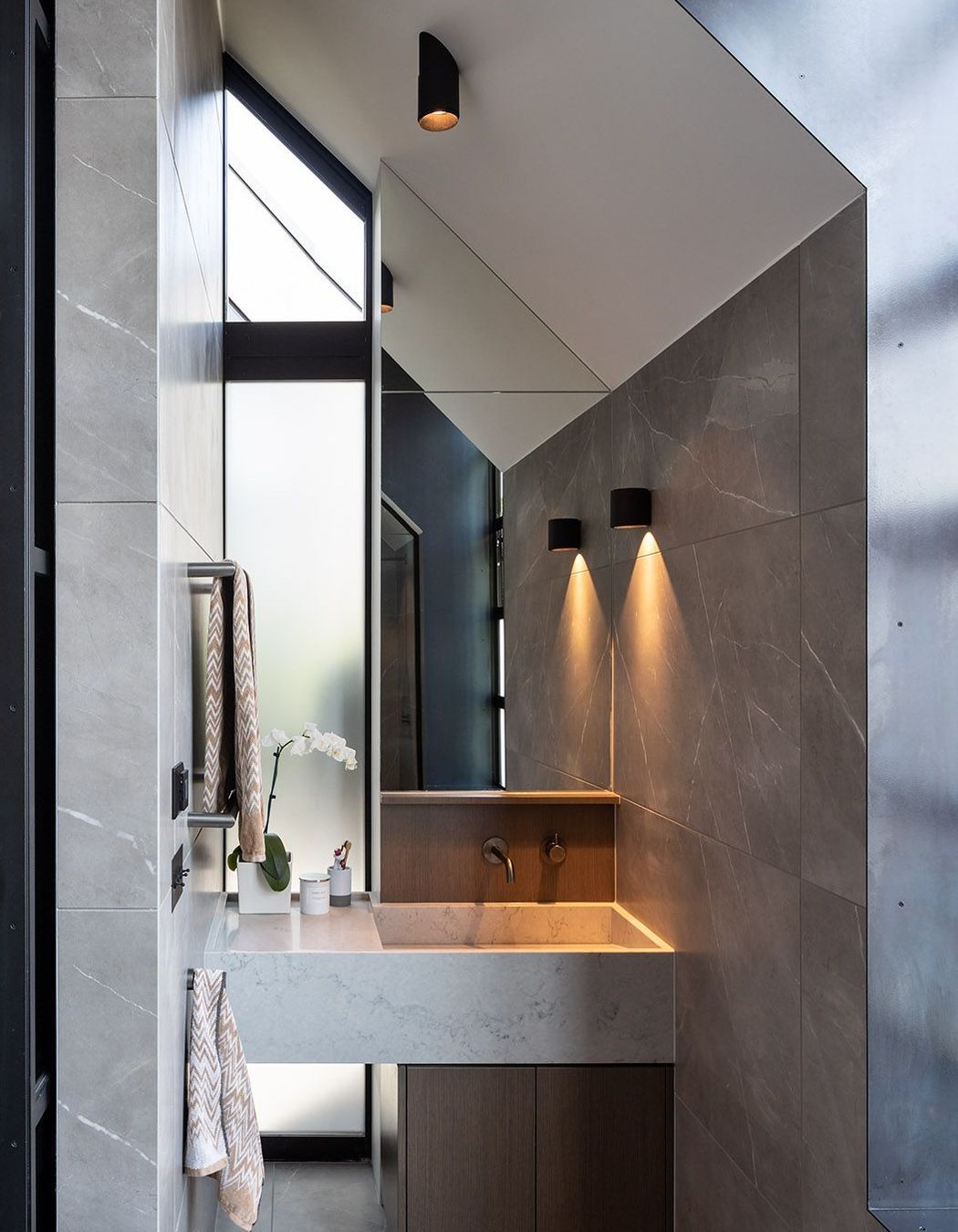 The ensuite bathroom is defined by the pitched roofline.