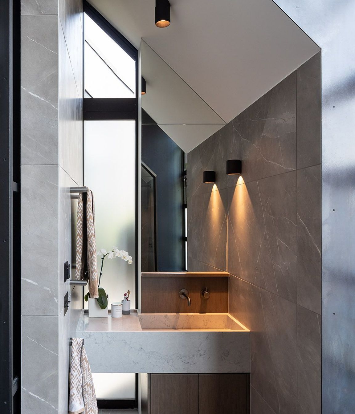 The ensuite bathroom is defined by the pitched roofline.