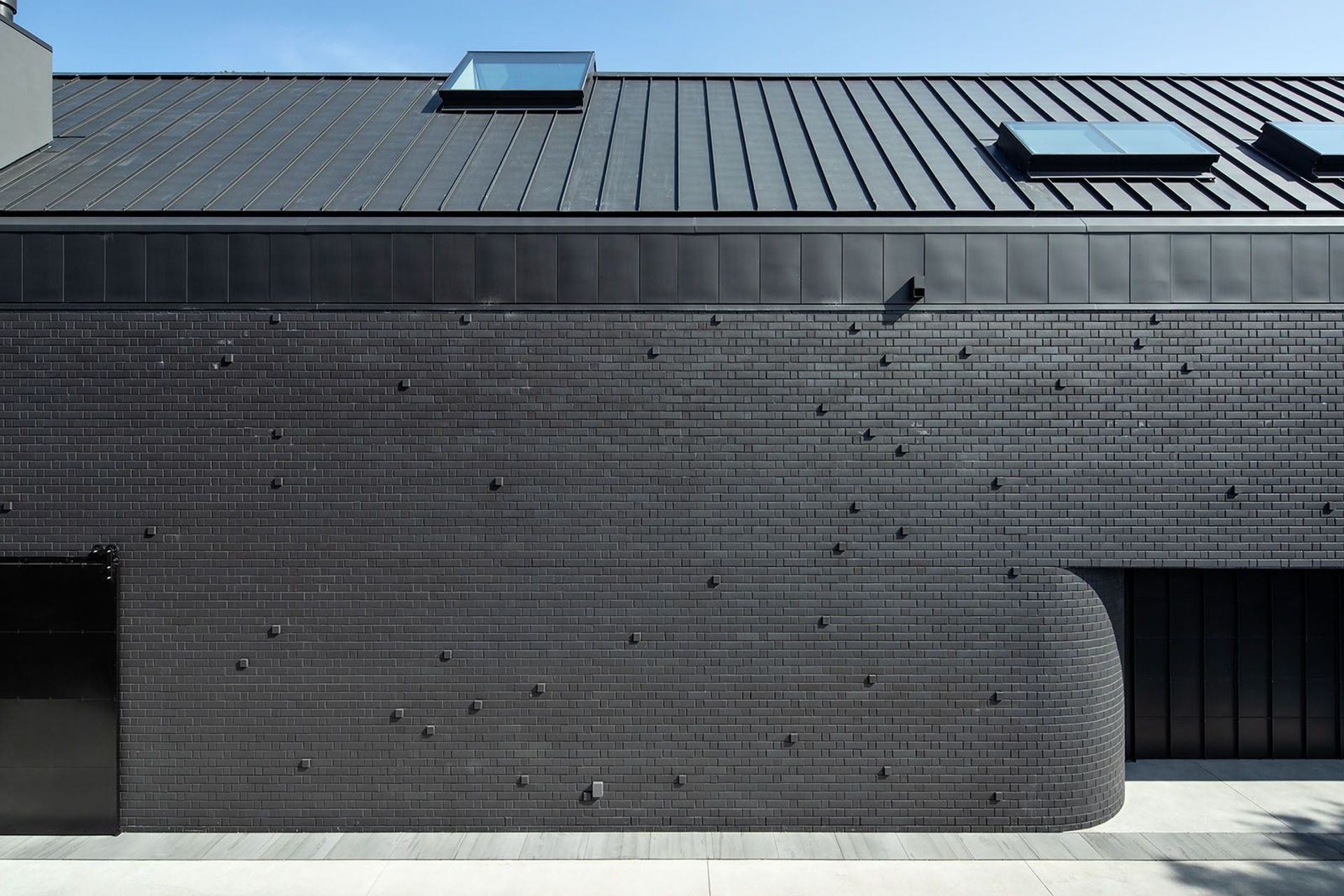 This windowless elevation is characterised by a series of brick 'pull outs' that add texture and interest to the Flemish bond pattern.