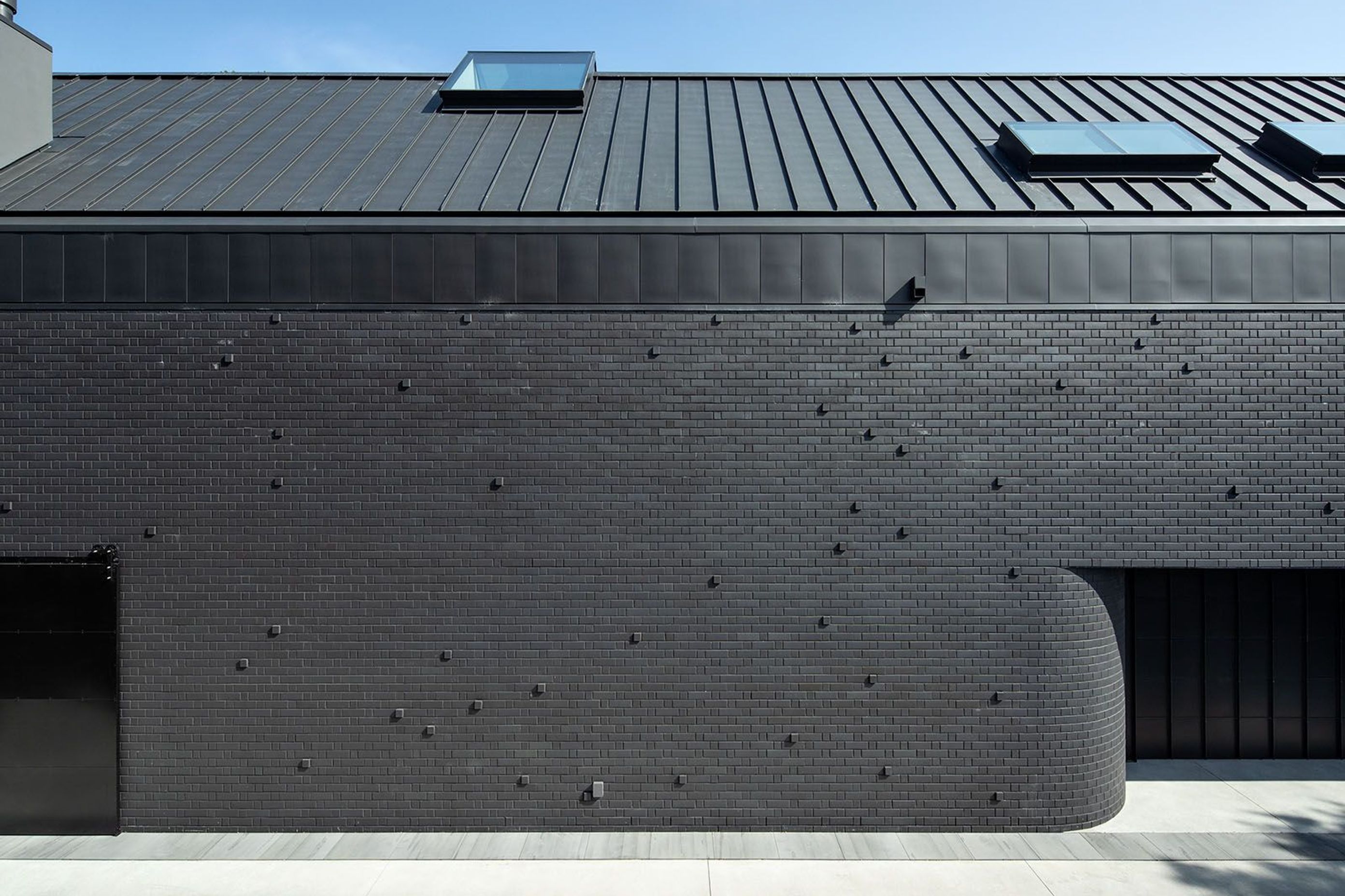This windowless elevation is characterised by a series of brick 'pull outs' that add texture and interest to the Flemish bond pattern.