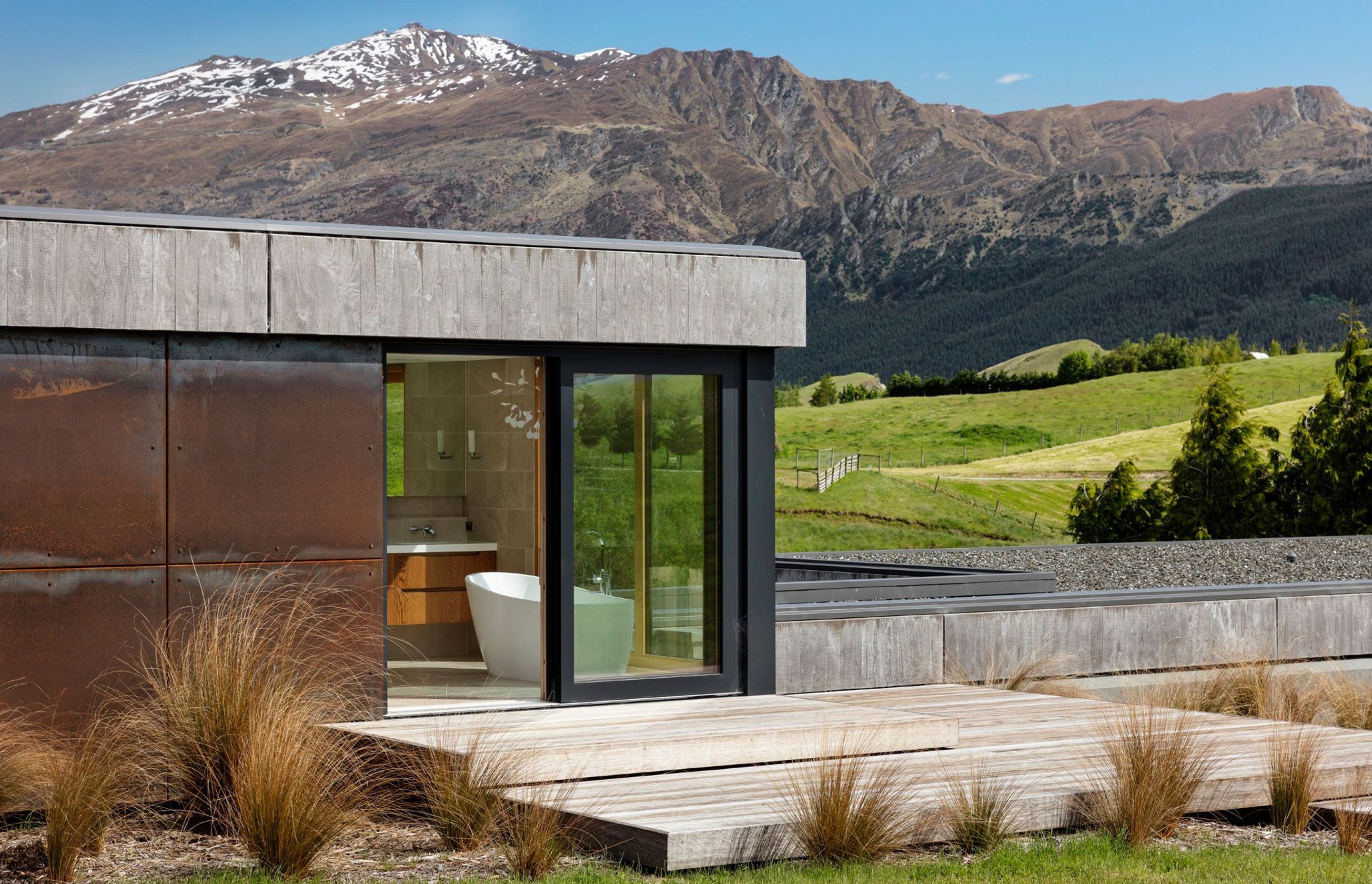 The 'eagle's nest' bathroom in the master suite. The exterior features Corten steel panels, concrete and timber to blend the building into the surrounding landscape.