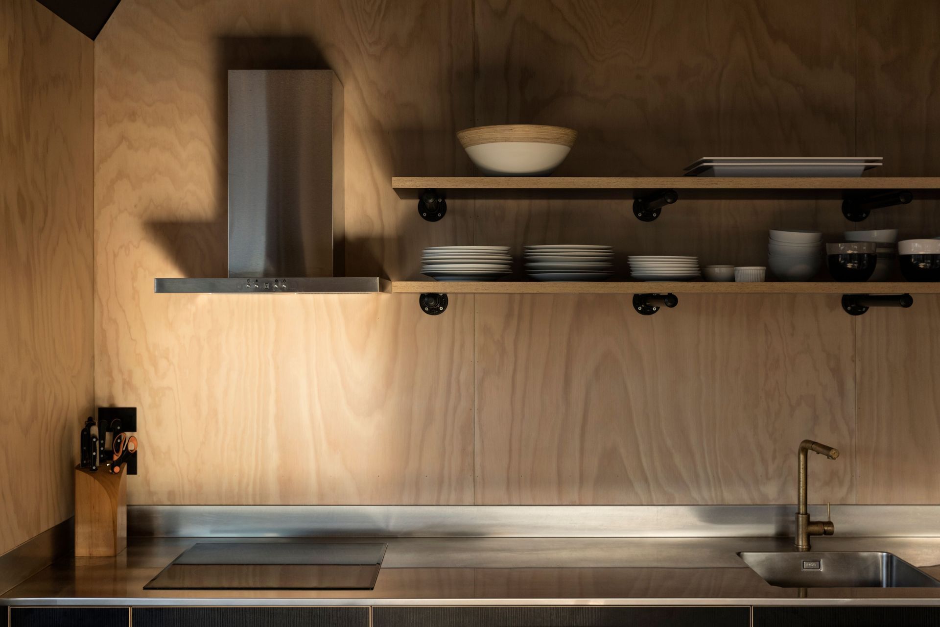 The choice of plywood for interior walls makes for a warm, relaxed kitchen.