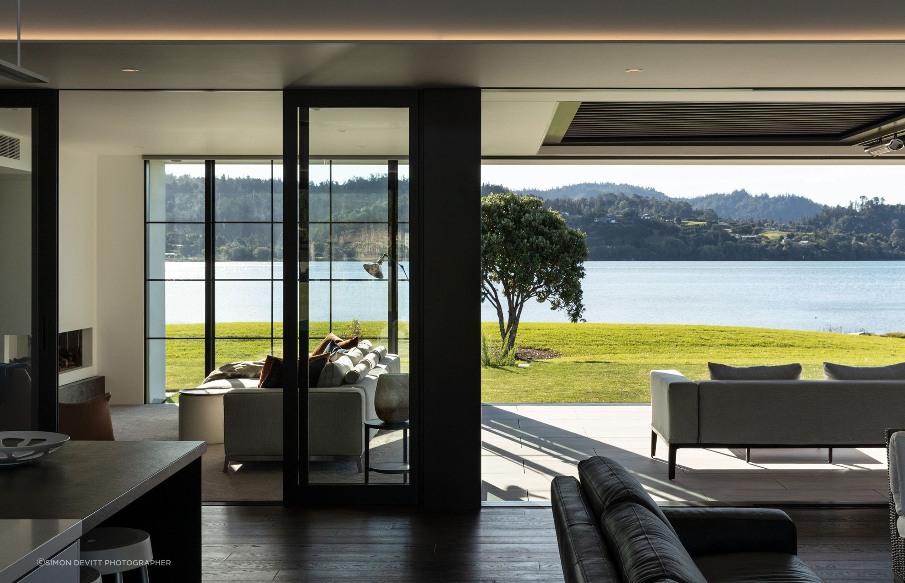 Indoor and outdoor lounges open up with sliding doors to the lawn and the view.