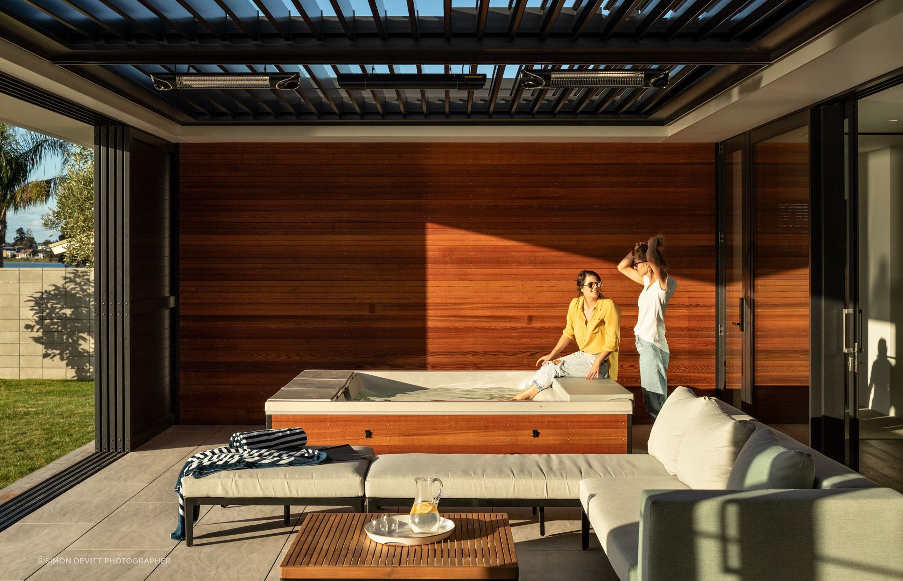 The outdoor room features a spa pool and a roof that opens up to the elements.