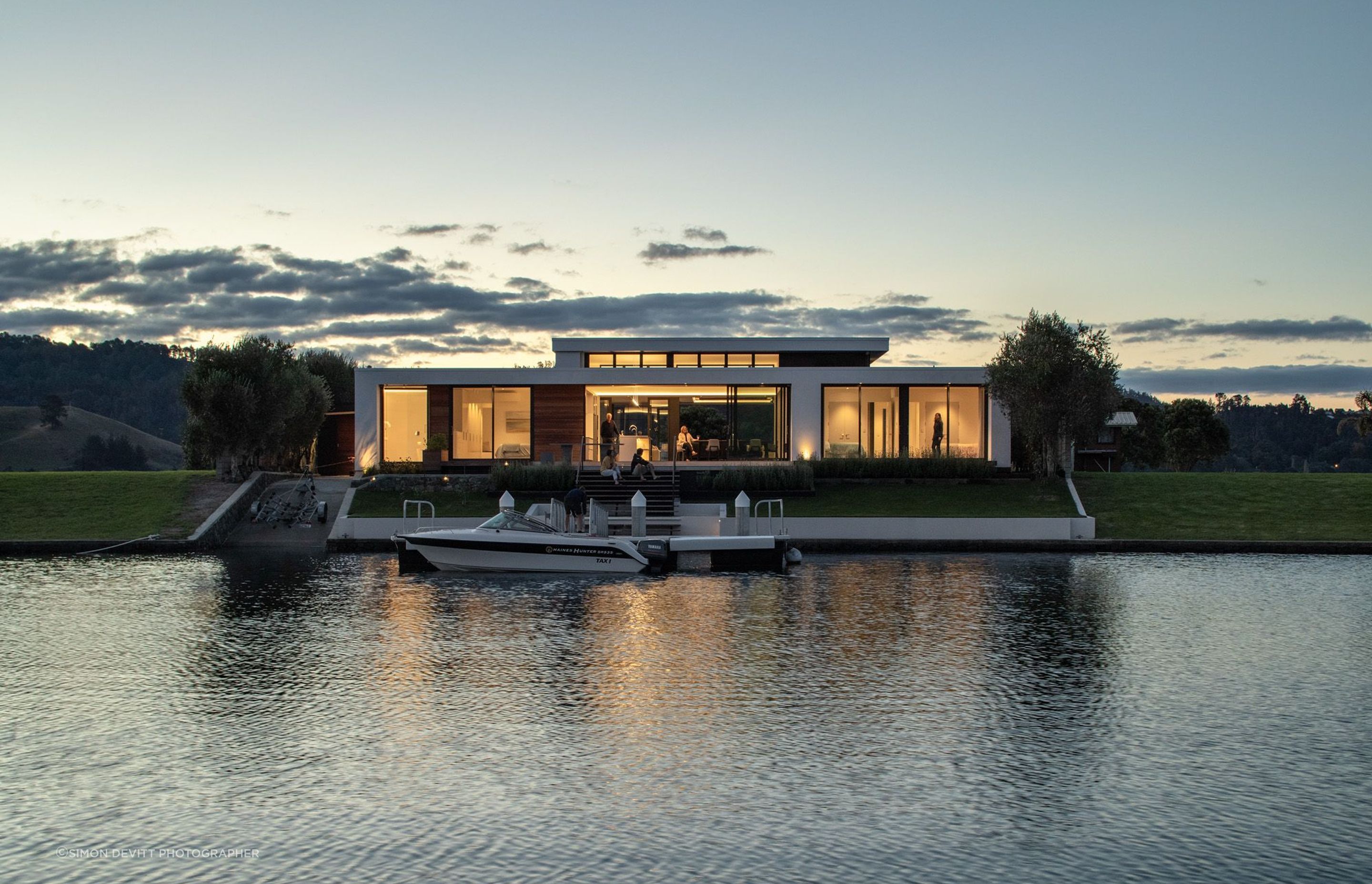 The house and boat seen from the canal at night.