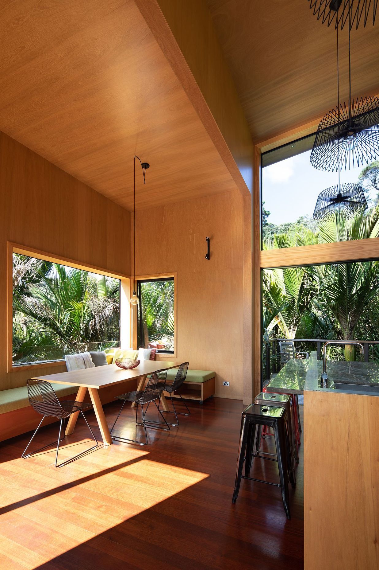 The kitchen/dining area maximises space with built-in bench seating and high ceilings.