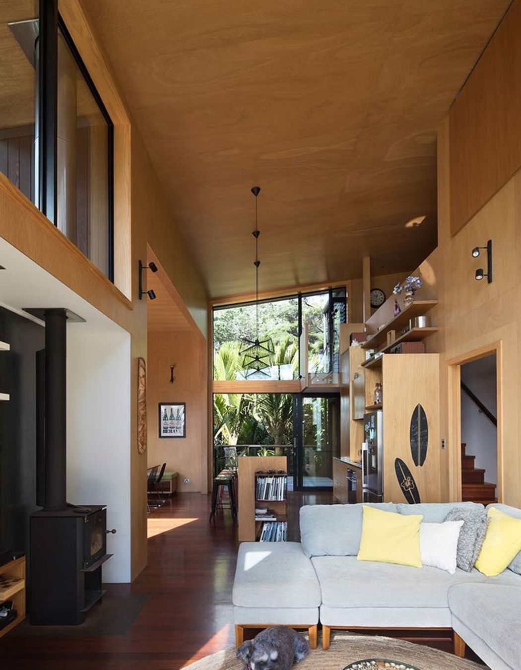 The high ceilings comfortably provide several living spaces within the small footprint, promoting social closeness that larger houses may not.
