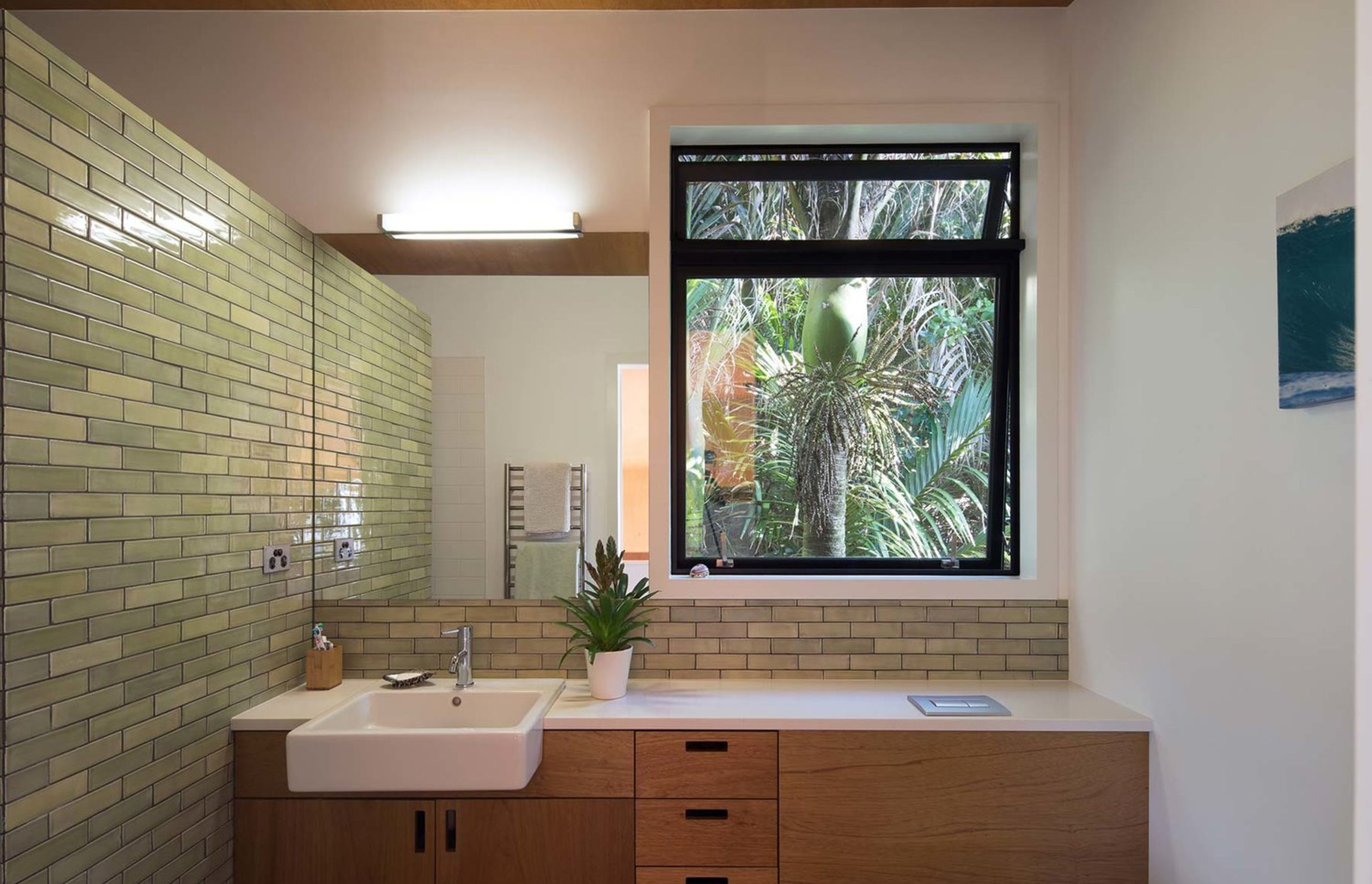 Use of green tiles connects the bathroom spaces with the outside environment, bringing the ‘outside’ to the ‘inside’.  