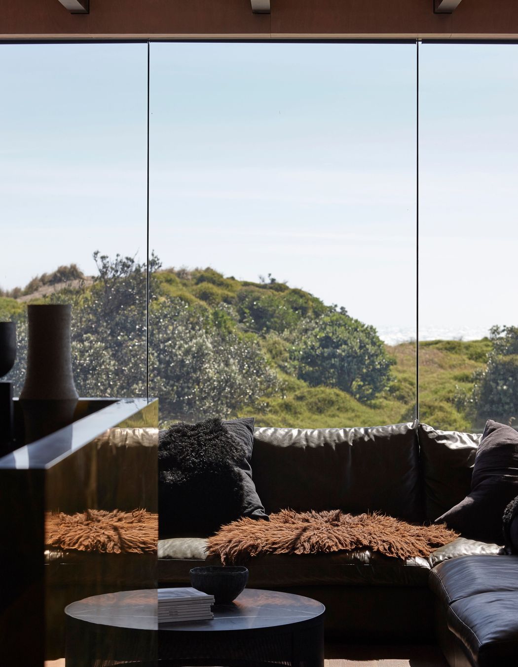 Low-E glass contributes to the feeling that the home is only moments away from being plunged into the elements.