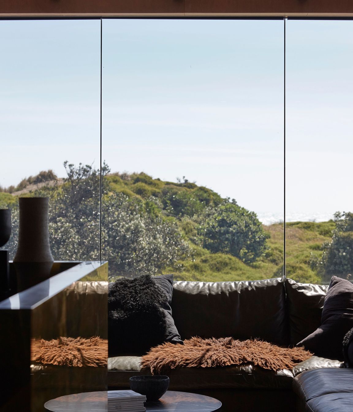 Low-E glass contributes to the feeling that the home is only moments away from being plunged into the elements.