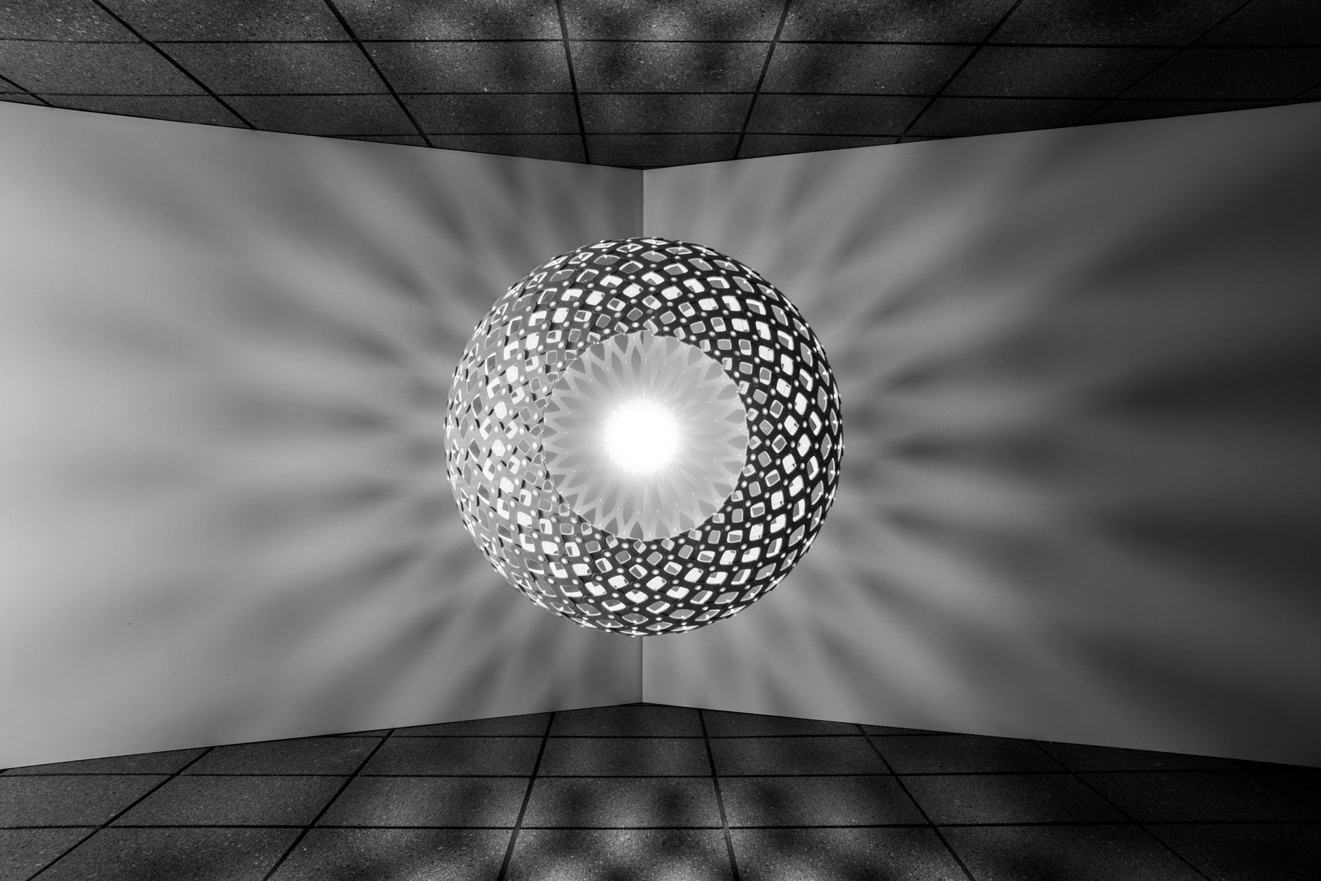 Trubridge light over the entry casts shadows across the ceiling and block walls.