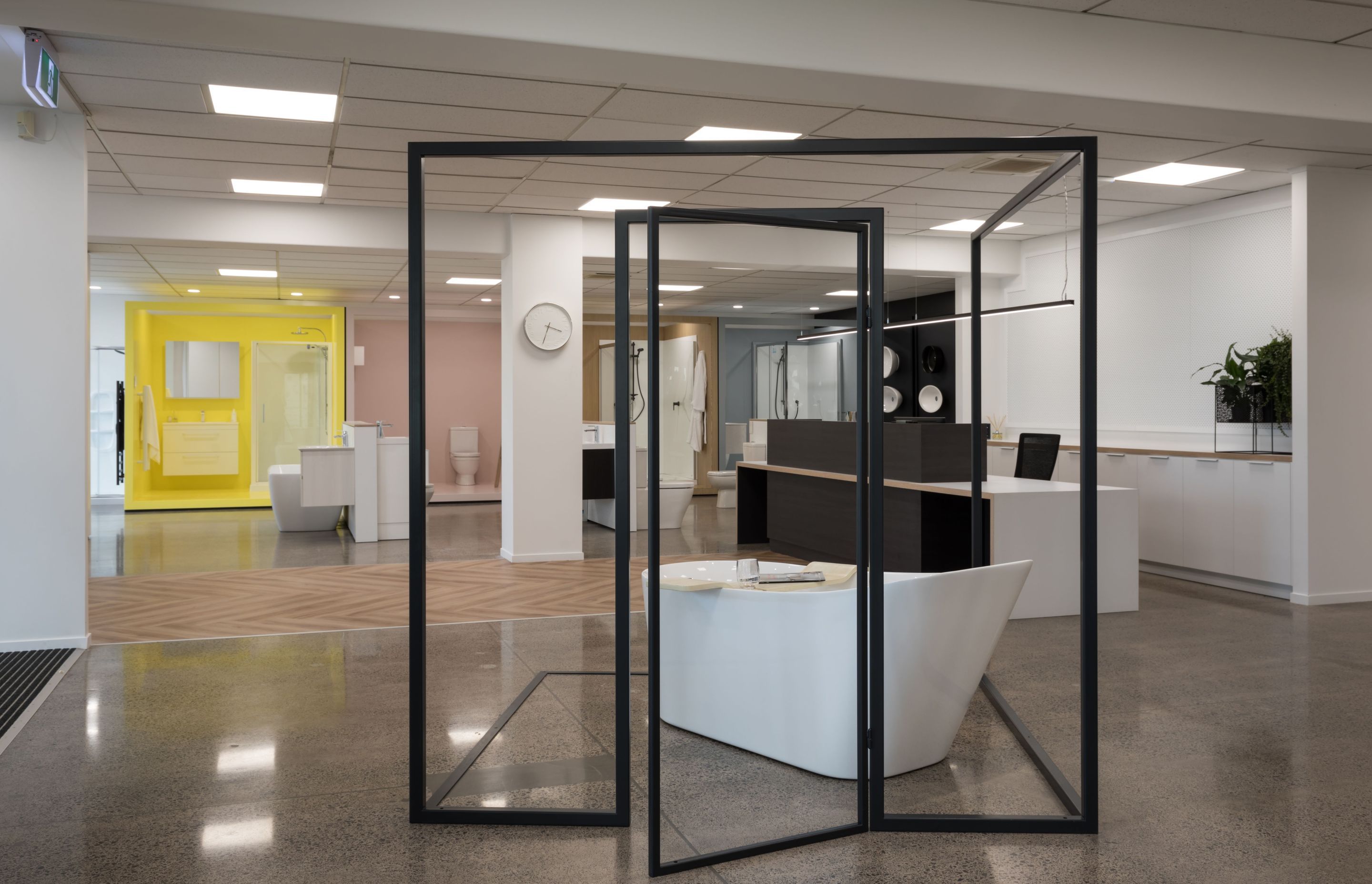 The suggestion of a room within a room, framed in steel is the showroom centre piece.