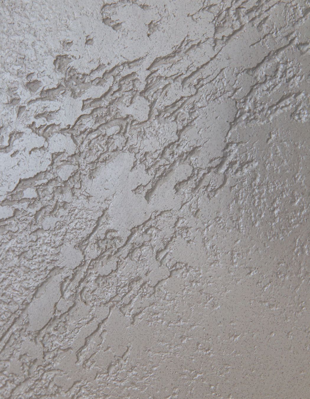 Details of white textured polished plaster