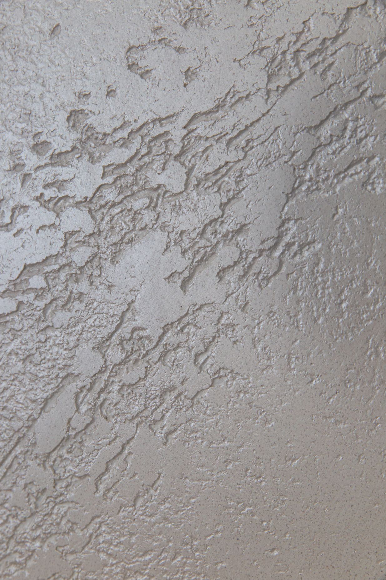 Details of white textured polished plaster