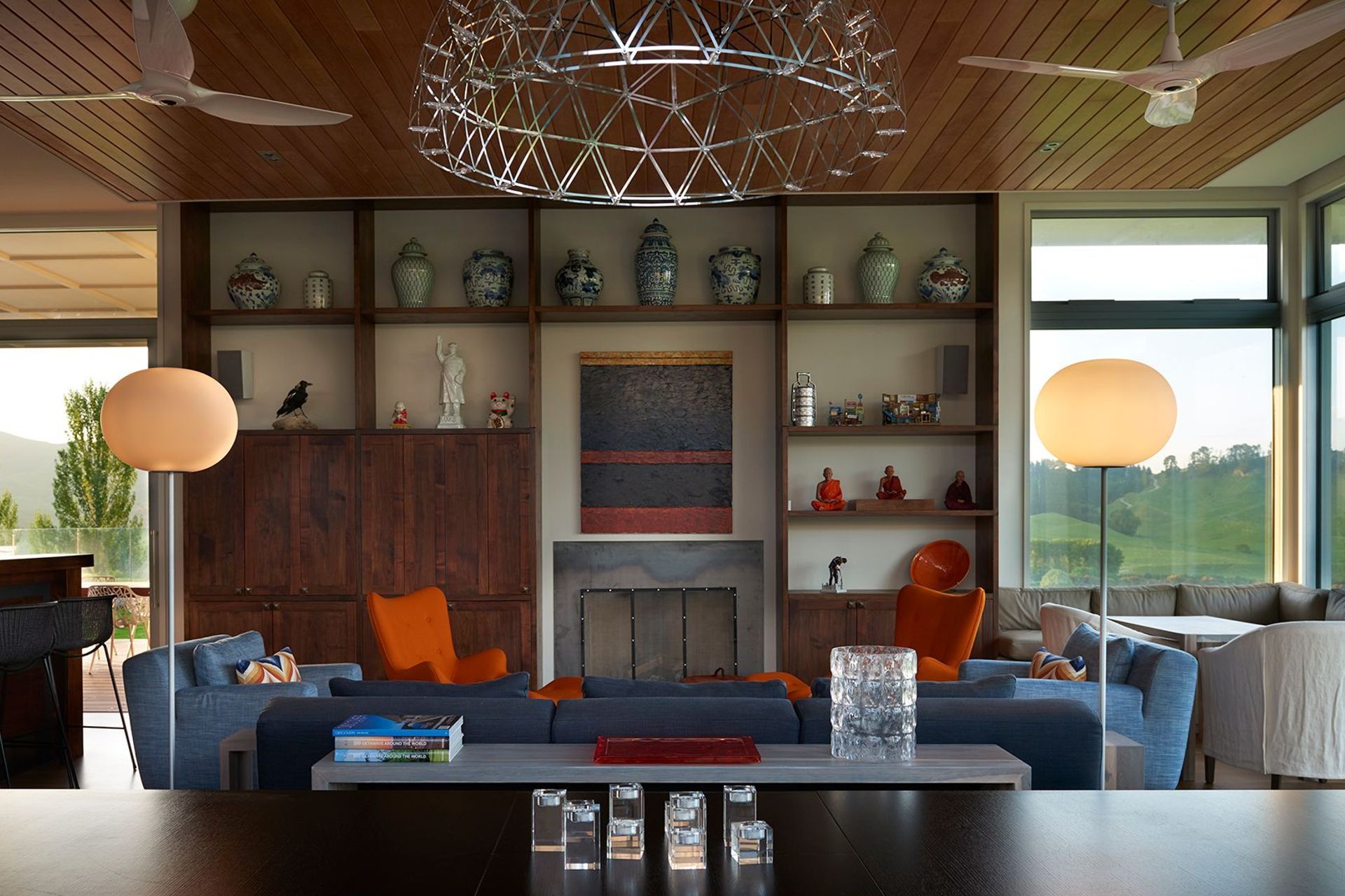 Built-in acacia cabinetry features the owner's collection of Asian vases and objects, along with a painting by JS Parker above the fireplace.