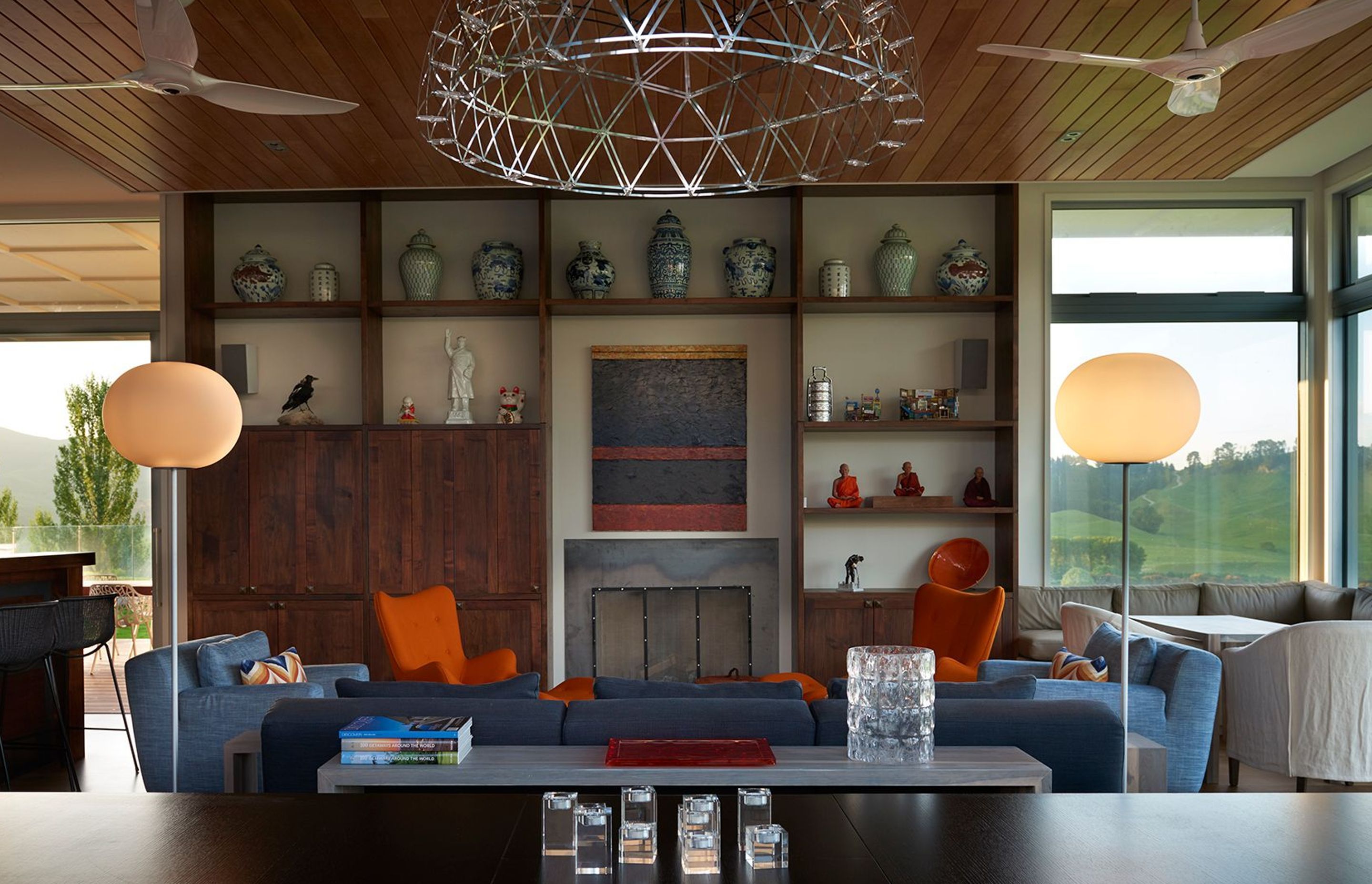 Built-in acacia cabinetry features the owner's collection of Asian vases and objects, along with a painting by JS Parker above the fireplace.