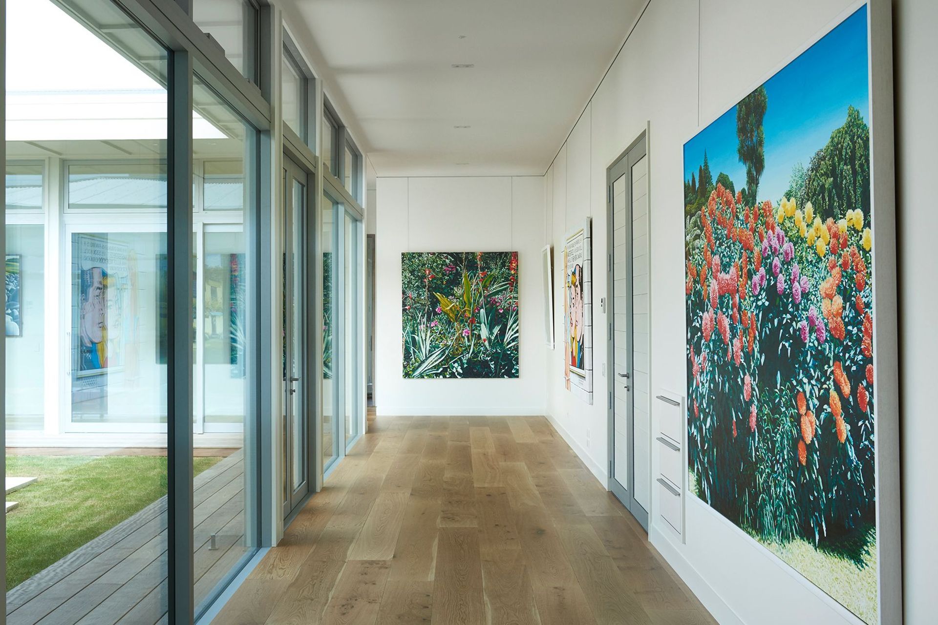 The corridor between the living and bedroom wings doubles as a gallery, featuring artworks by Nigel Brown, Karl Maughan, Stanley Palmer, and Ian Scott.