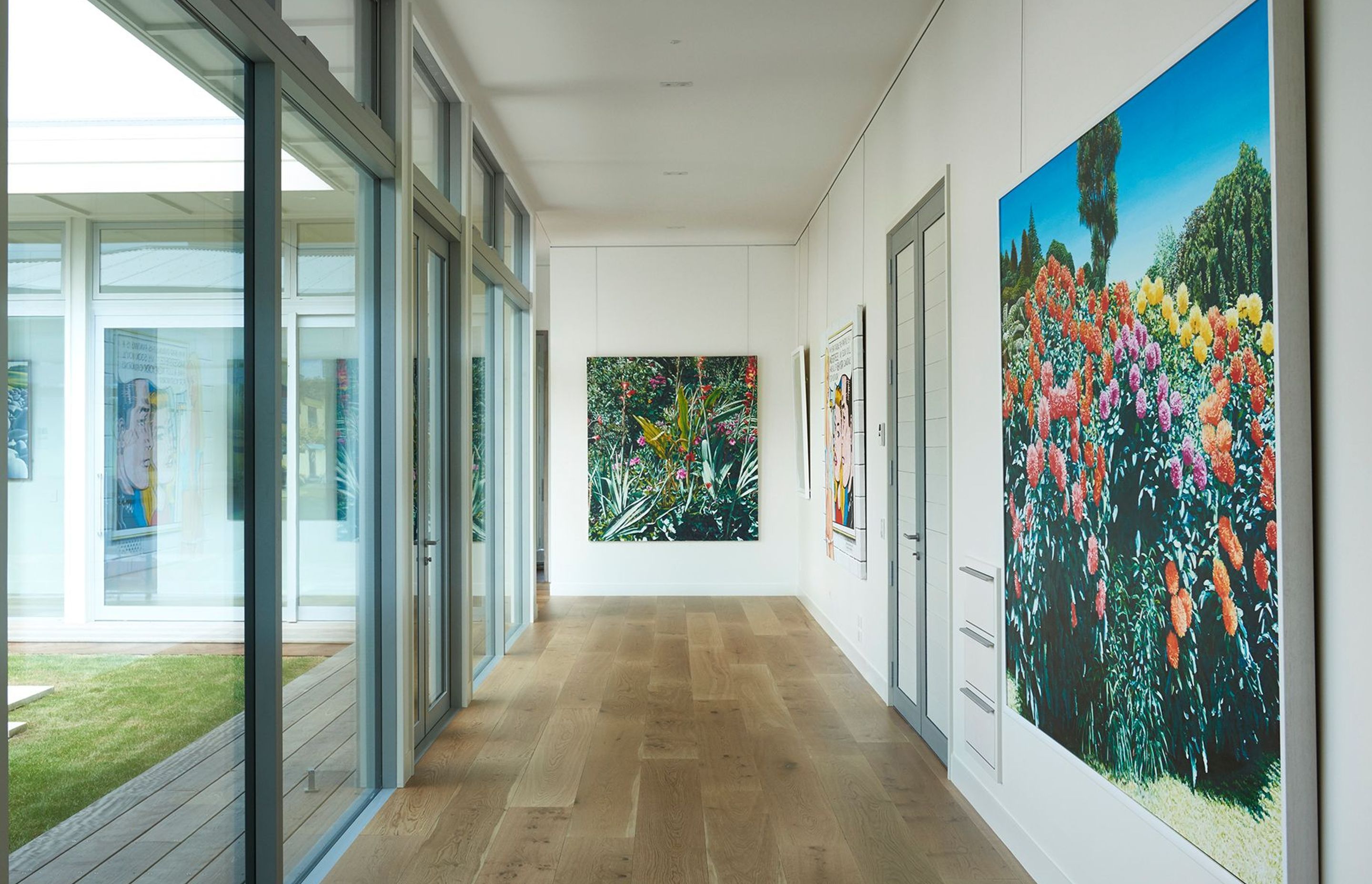 The corridor between the living and bedroom wings doubles as a gallery, featuring artworks by Nigel Brown, Karl Maughan, Stanley Palmer, and Ian Scott.