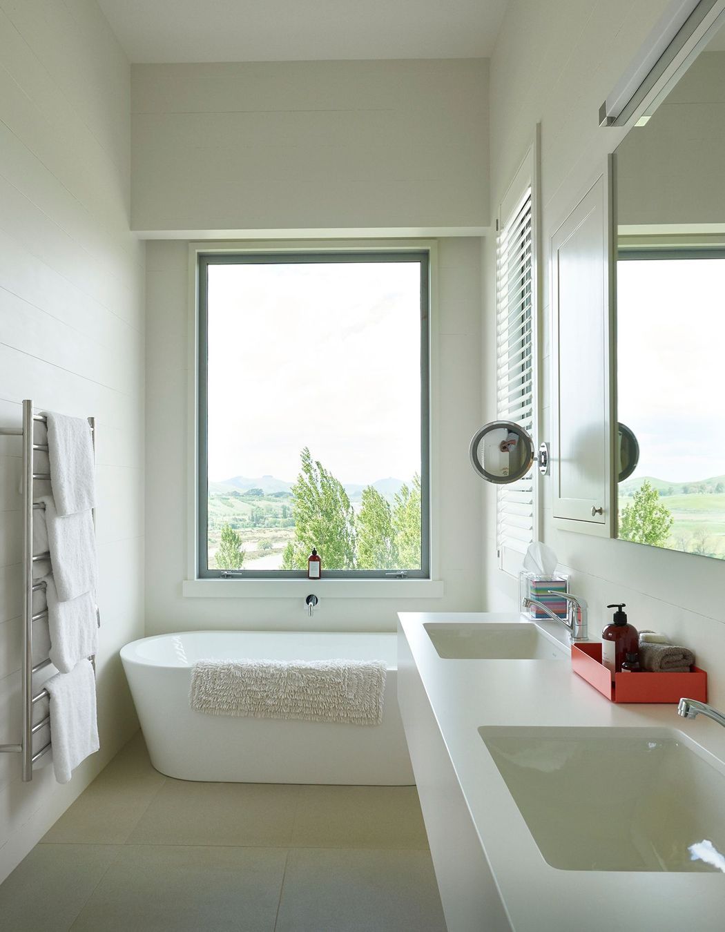 This bathroom enjoys a picture postcard view of the hilltops.