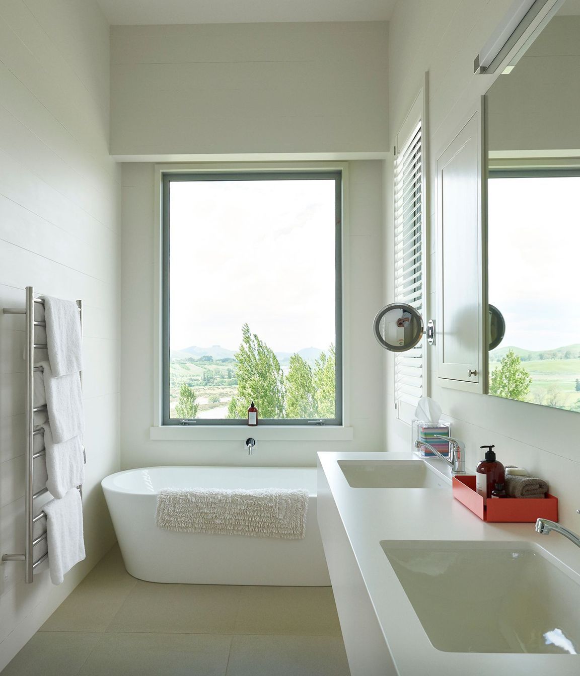 This bathroom enjoys a picture postcard view of the hilltops.