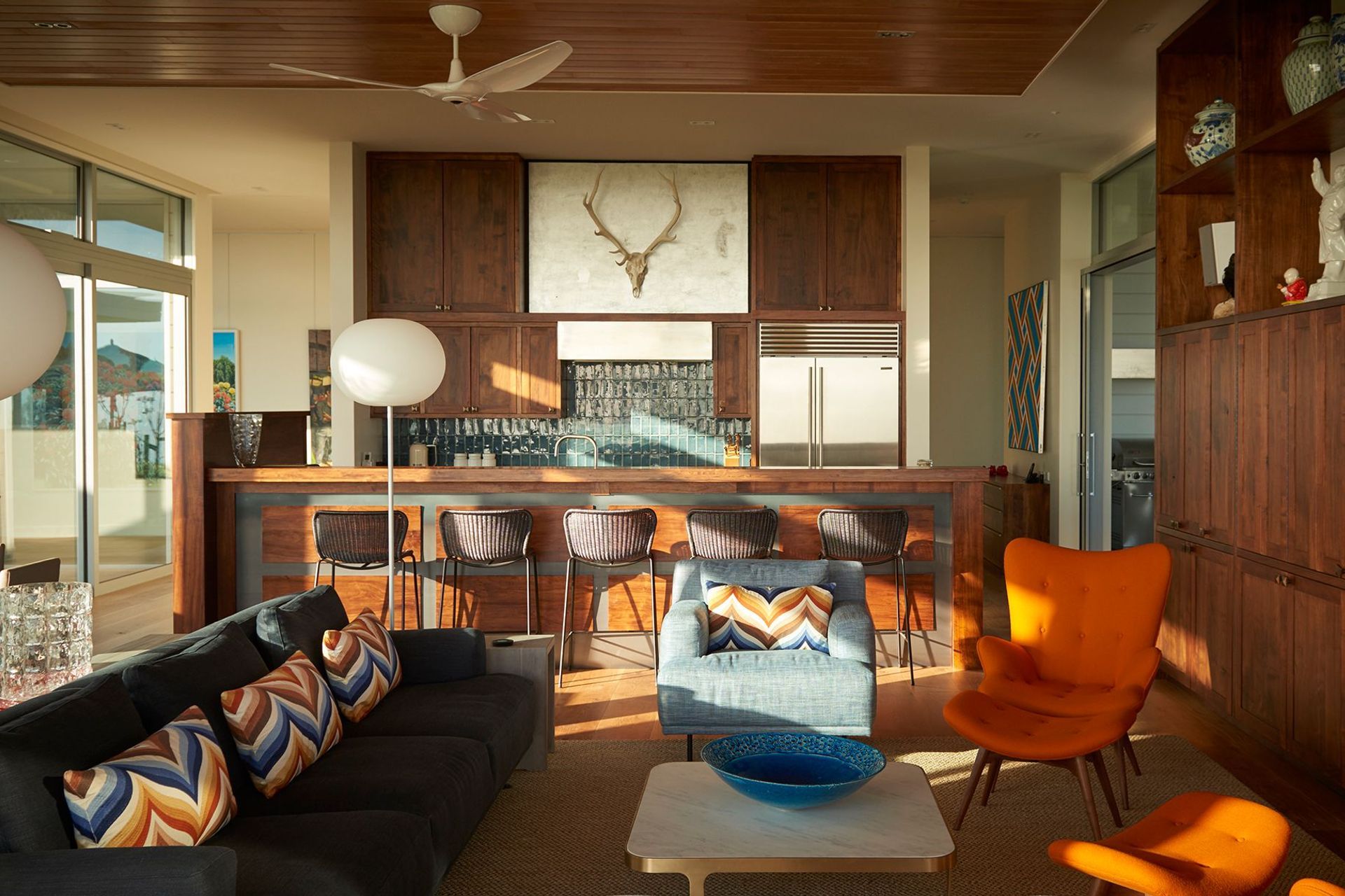 The interior design by Brigit Christie features a natural base palette of colours and materials, with accents of colour and texture, and bold mid-century modern furniture.